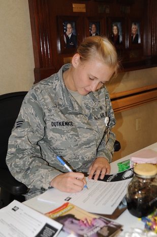 Senior Airman Alyssa Dutkiewicz signs a pledge at the Joint Base Medical Group clinic Nov.10. The pledge was part of the "Great American Smokeout" which is held every November as a means for smokers to quit smoking for at least one day. Dutkiewicz is a medical technician with the 628th Medical Group. (U.S. Air Force photo/Airman 1st Class Ashlee Galloway)