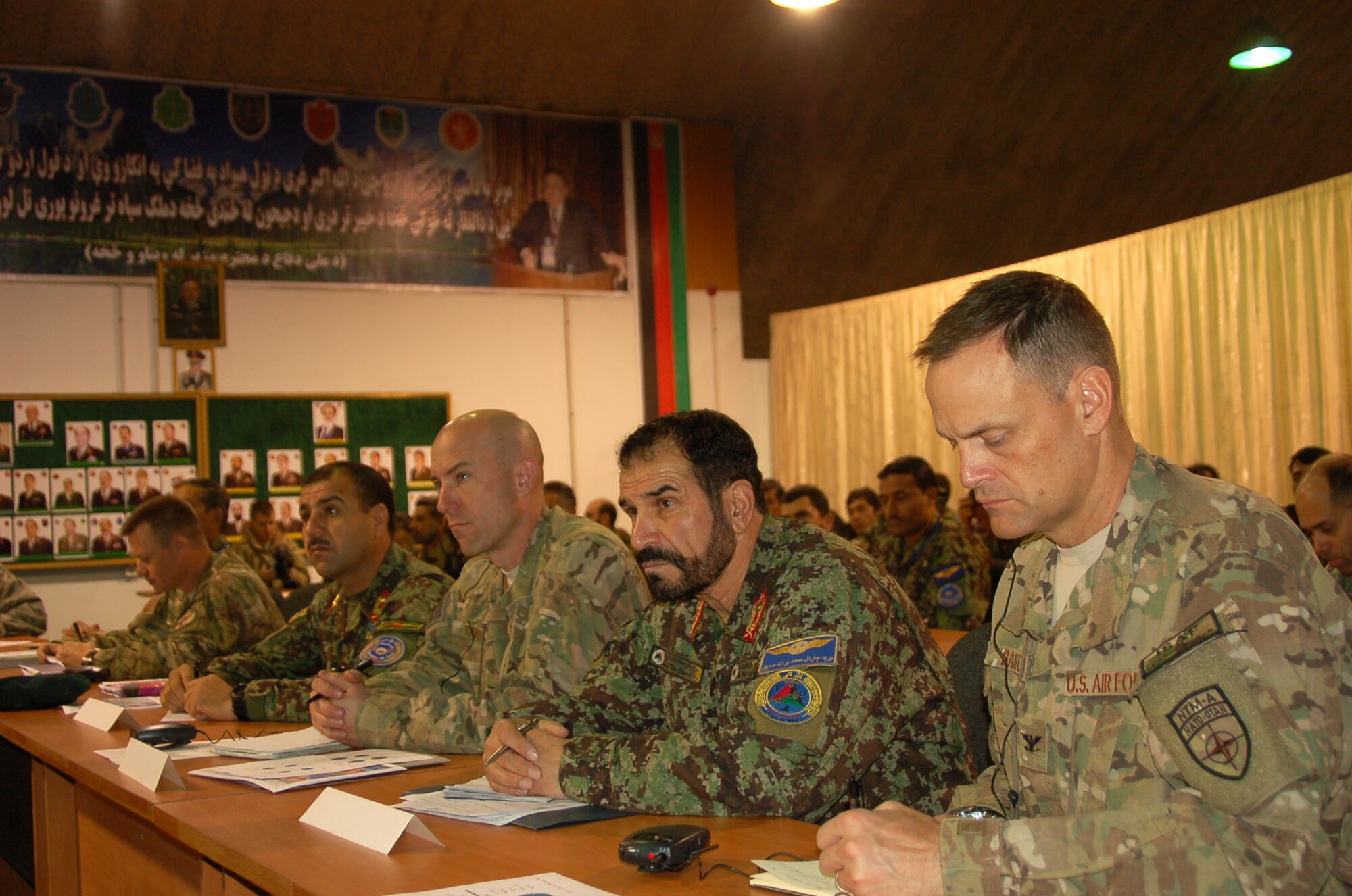 U.S. and Afghan military leaders listen intently to a briefing at a status of training seminar held at Kabul International Airport, Nov. 28 and 29.(Afghan Air Force photo/Sgt. Sayed Padsha)