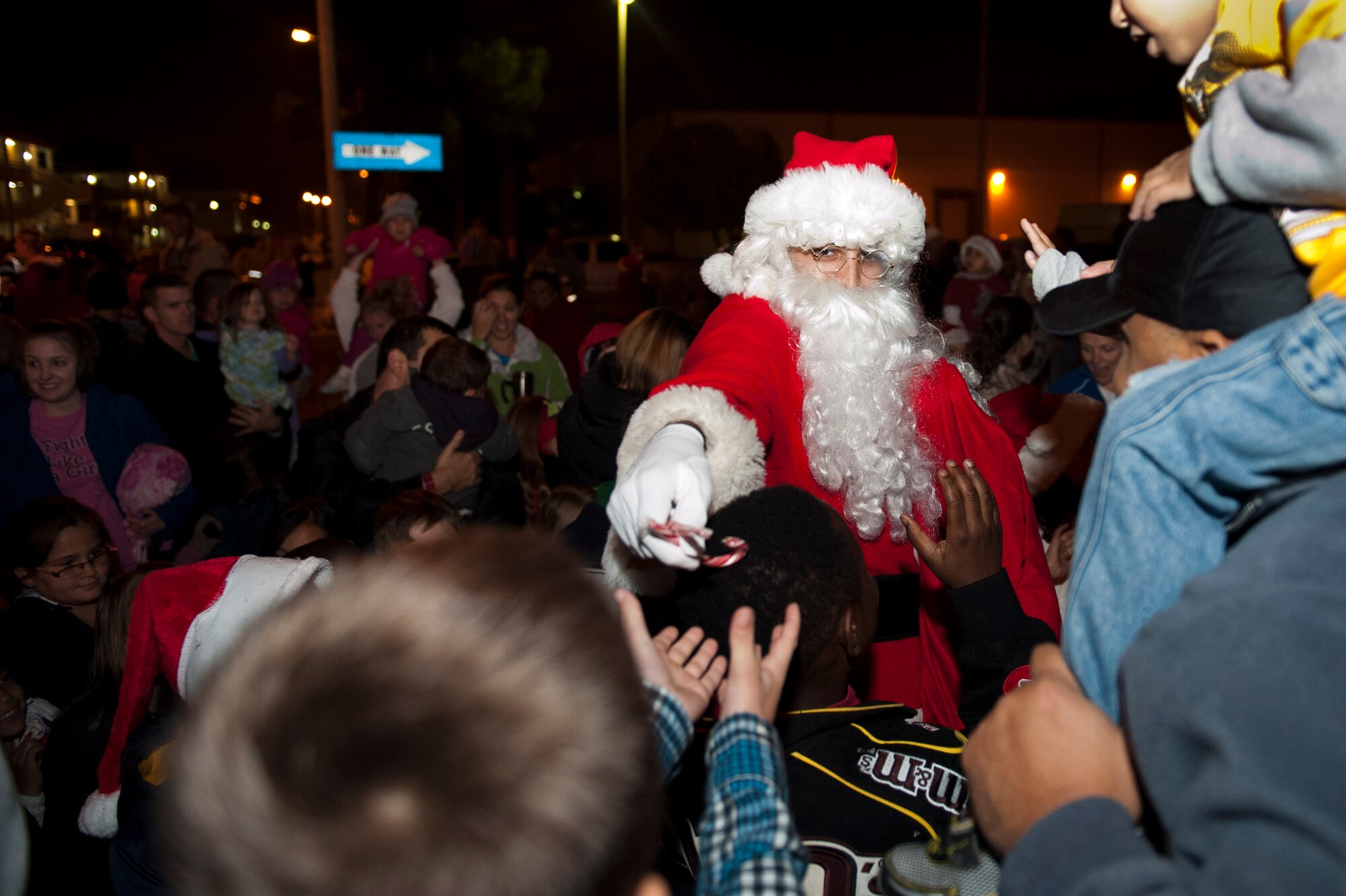 Santa Claus passes out candy canes to people outside the Club Complex during the base tree lighting ceremony Nov. 28, 2011, at Incirlik Air Base, Turkey.  Col. Chris Craige, 39th Air Base Wing commander, and his children flipped the switch to light the holiday tree. (U.S. Air Force photo by Senior Airman Anthony Sanchelli/Released)