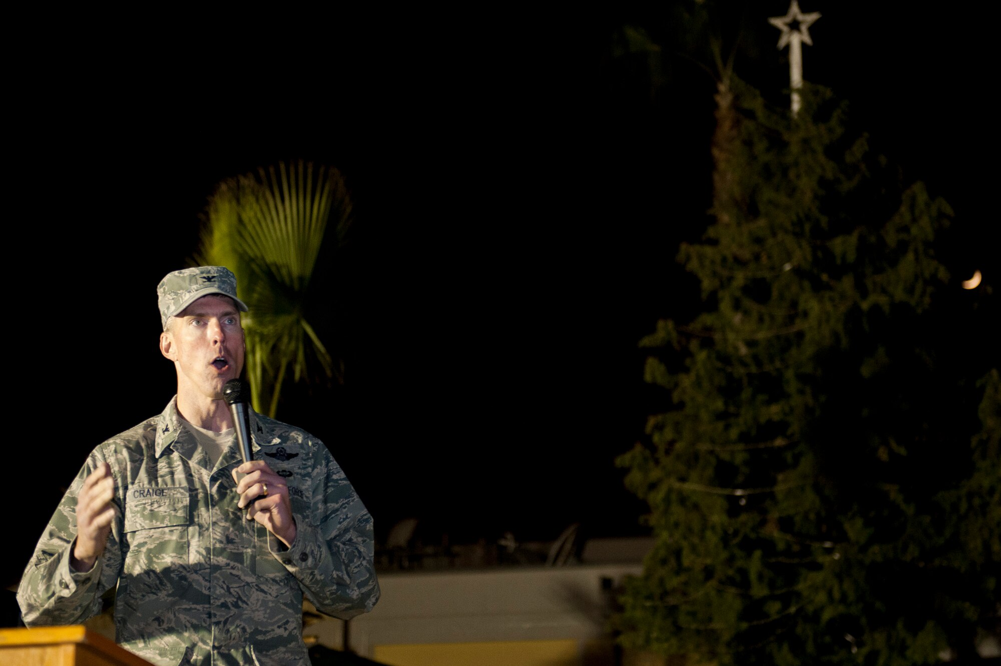 Col. Chris Craige, 39th Air Base Wing commander, speaks to a crowd gathered outside the Club Complex during the base tree lighting ceremony Nov. 28, 2011, at Incirlik Air Base, Turkey. The Incirlik Elementary School choir performed and Santa Claus arrived on a fire truck during the event. Craige and his children flipped the switch to light the holiday tree. (U.S. Air Force photo by Senior Airman Anthony Sanchelli/Released)