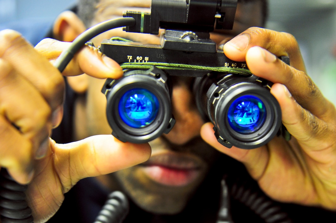 U.S. Navy Seaman Randy Harmon performs tests on a night-vision scope aboard the aircraft carrier USS George H.W. Bush in the Mediterranean Sea, Nov. 21, 2011. Harmon is an aviation electrician's mate airman. The George H.W. Bush is supporting maritime security operations and theater security cooperation efforts in the U.S. 6th Fleet area of responsibility.