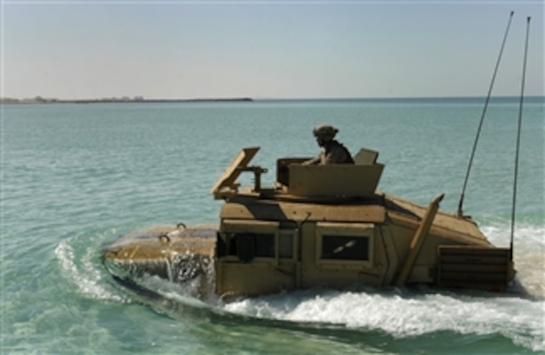 A Marine from the 22nd Marine Expeditionary Unit drives a Humvee to shore after launching from a landing craft utility assigned to the amphibious dock landing ship USS Whidbey Island (LSD 41) in the Arabian Gulf on Nov. 14, 2011.  The Whidbey Island is deployed as part of the Bataan Amphibious Ready Group supporting maritime security operations and theater security cooperation efforts in the U.S. 5th Fleet area of responsibility.  