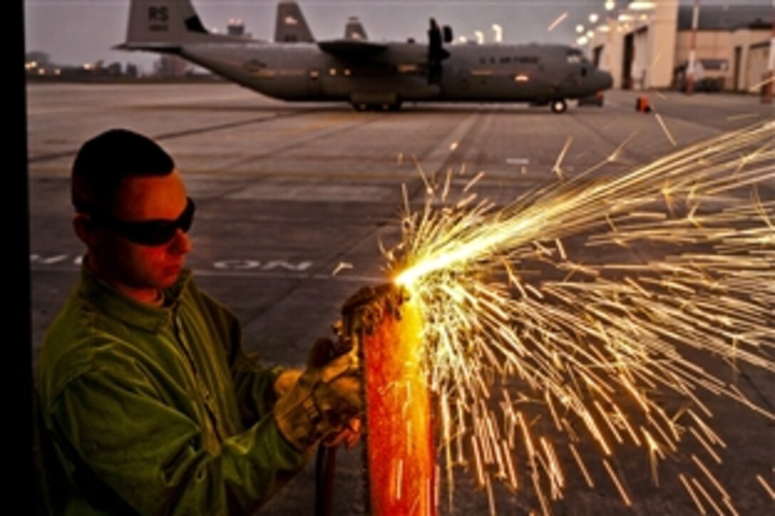 U.S. Air Force Staff Sgt. Daniel Kay cuts diamond-plate steel with an oxyacetylene torch on Ramstein Air Base, Germany, Nov. 22, 2011. Kay is an aircraft metals technology craftsman assigned to the 86th Maintenance Squadron.