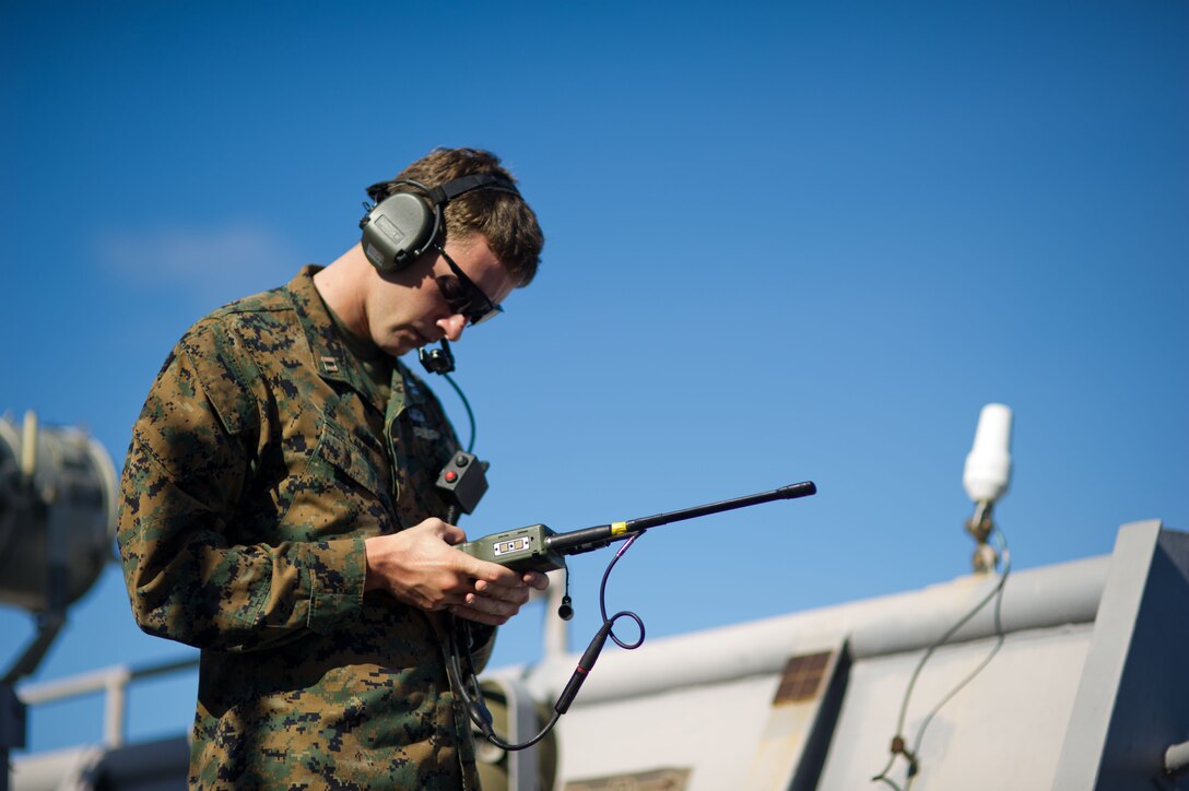 Navy Lt. James E. Lamb conducts a communications check aboard USS Pearl Harbor here Nov. 29. Lamb, 26, hails from Minneapolis and serves as a firepower control team leader with the 11th Marine Expeditionary Unit. The unit embarked USS Makin Island, USS New Orleans and USS Pearl Harbor in San Diego Nov. 14, beginning a seven-month deployment to the Western Pacific and Middle East regions.