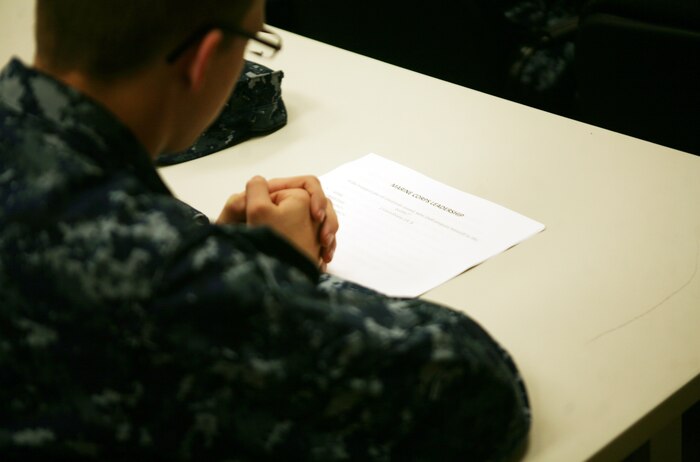 A sailor with the 2nd Marine Logistics Group reads over a copy of the Marine Corps Leadership traits and principles during a period of military education at the 2nd MLG Chaplain Center aboard Camp Lejeune, N.C., Nov. 30, 2011. During the PME, Sgt. Maj. Herbert W. Wrench, the 2nd MLG sergeant major, explained each trait and principle in detail to the religious ministry teams from across the unit. (U.S. Marine Corps photo by Pfc. Franklin E. Mercado)