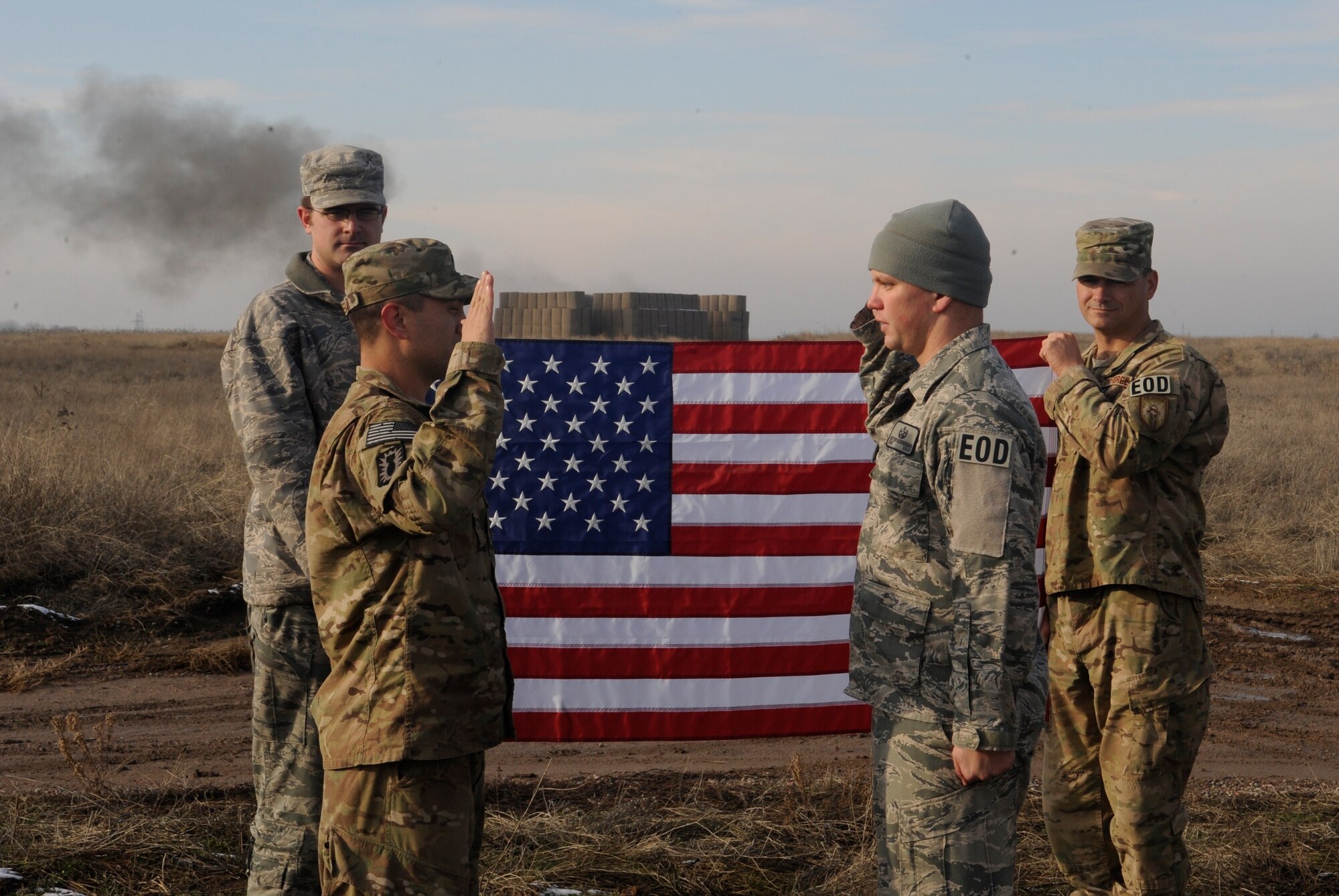 Capt. Brennan Vincello reenlists Staff Sgt. Matt Leatherman during a controlled detonation at the explosive ordnance disposal range at the Transit Center at Manas, Kyrgyzstan, Nov. 29, 2011. Leatherman is a 376th Expeditionary Civil Engineer Squadron EOD technician. Vincello is an EOD officer returning home from a deployment to Camp Leatherneck, Afghanistan. The Airmen both deployed from Mountain Home Air Force Base, Idaho. (U.S. Air Force photo/Tech. Sgt. Tammie Moore)