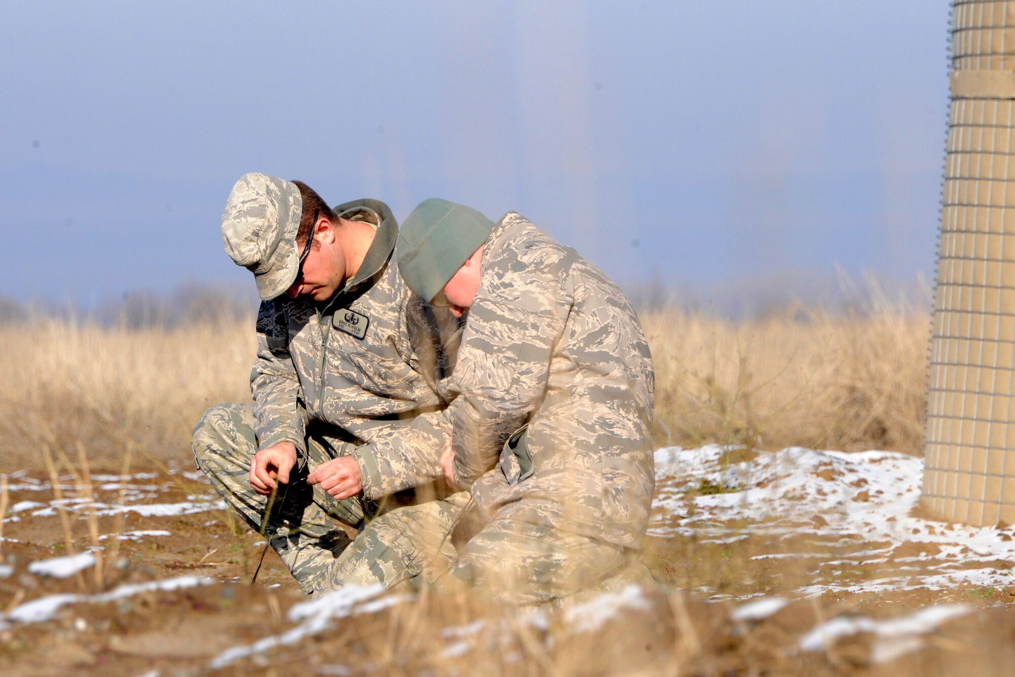 Airman 1st Class Eric Holm (left) and Staff Sgt. Paul Pest check out electronic detonators at the explosive ordnance disposal range at the Transit Center at Manas, Kyrgyzstan, Nov. 29, 2011.  The Airmen are both 376th Expeditionary Civil Engineer Squadron EOD technicians. Holm is deployed from Mountain Home Air Force Base, Idaho. Pest is deployed here from Seymour Johnson AFB, N.C. (U.S. Air Force photo/Tech. Sgt. Tammie Moore)