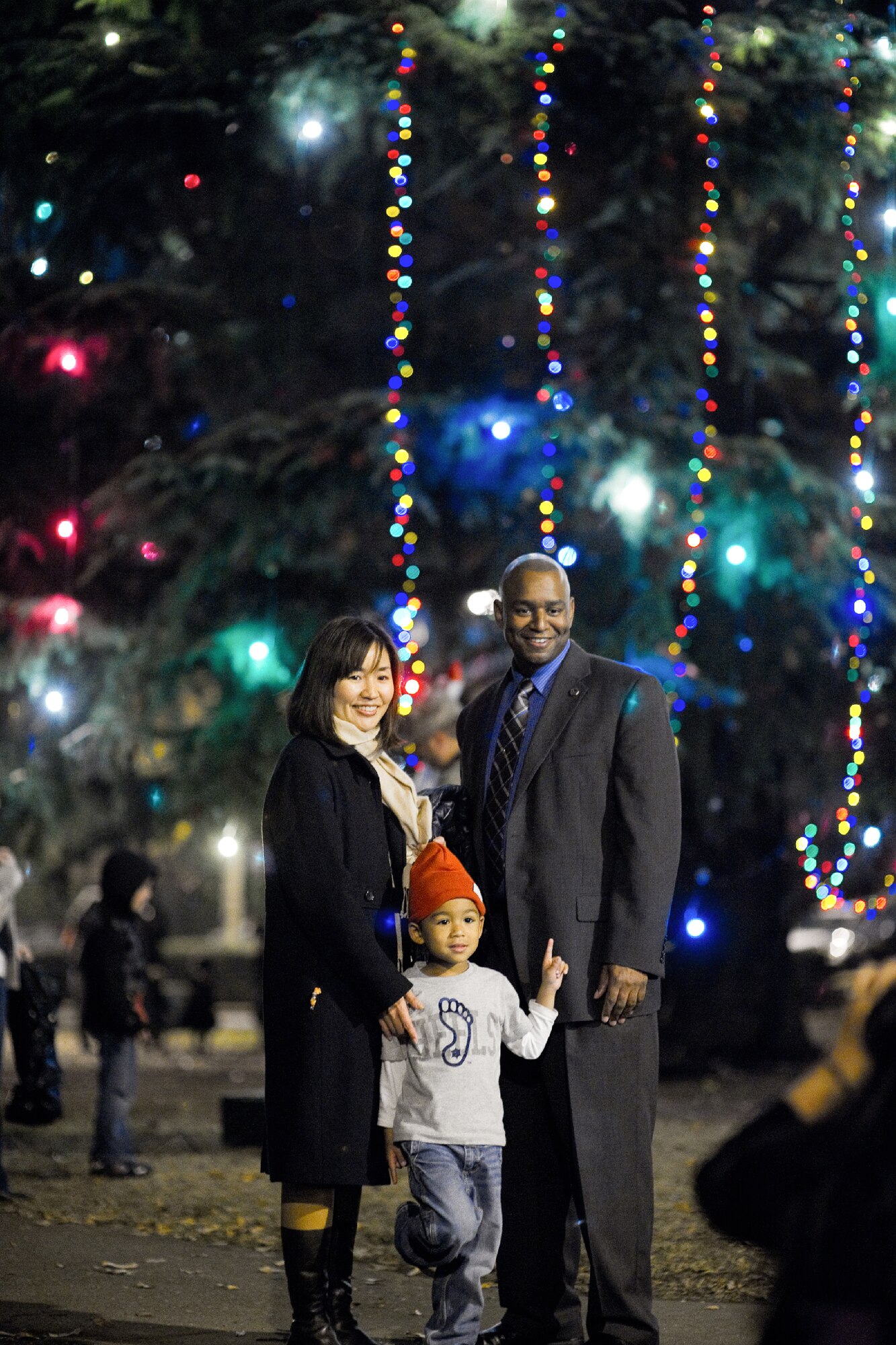 YOKOTA AIR BASE, Japan -- Robert Borden, 374th Airlift Wing inspector general, poses for a picture in front of the Yokota holiday tree with his wife Mio and son Conner following the tree lighting ceremony, Nov. 30, 2011. (U.S. Air Force photo/Osakabe Yasuo)