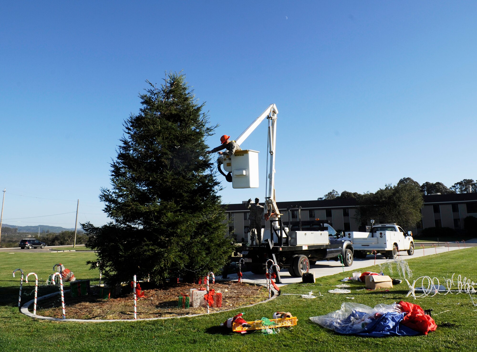 VANDENBERG AIR FORCE BASE, Calif. -- Vandenberg Airmen work to decorate the giant holiday tree at the intersection of California Boulevard and Utah Avenue here Wednesday, Nov. 30, 2011. Team Vandenberg personnel and their families are invited to attend the tree-lighting ceremony Tuesday, Dec. 6, 2011, at 4 p.m. (U.S. Air Force photo/Master Sgt. John Peters)