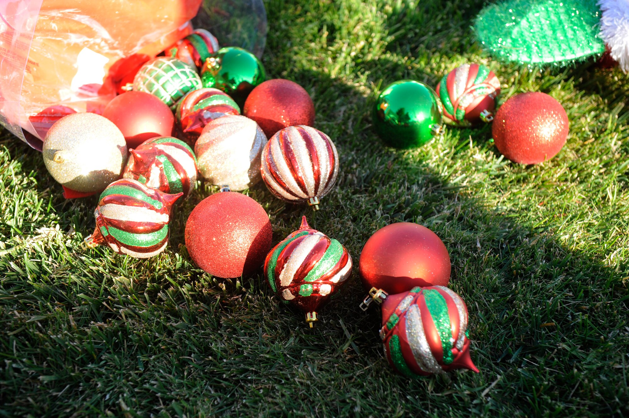 VANDENBERG AIR FORCE BASE, Calif. -- Colorful glass bulbs adorn the lawn while Team V Airmen decorate the tree in front of building 11777 here Wednesday, Nov. 30, 2011. Team Vandenberg personnel and their families are invited to attend the tree-lighting ceremony Tuesday, Dec. 6, 2011, at 4 p.m. (U.S. Air Force photo/Master Sgt. John Peters)