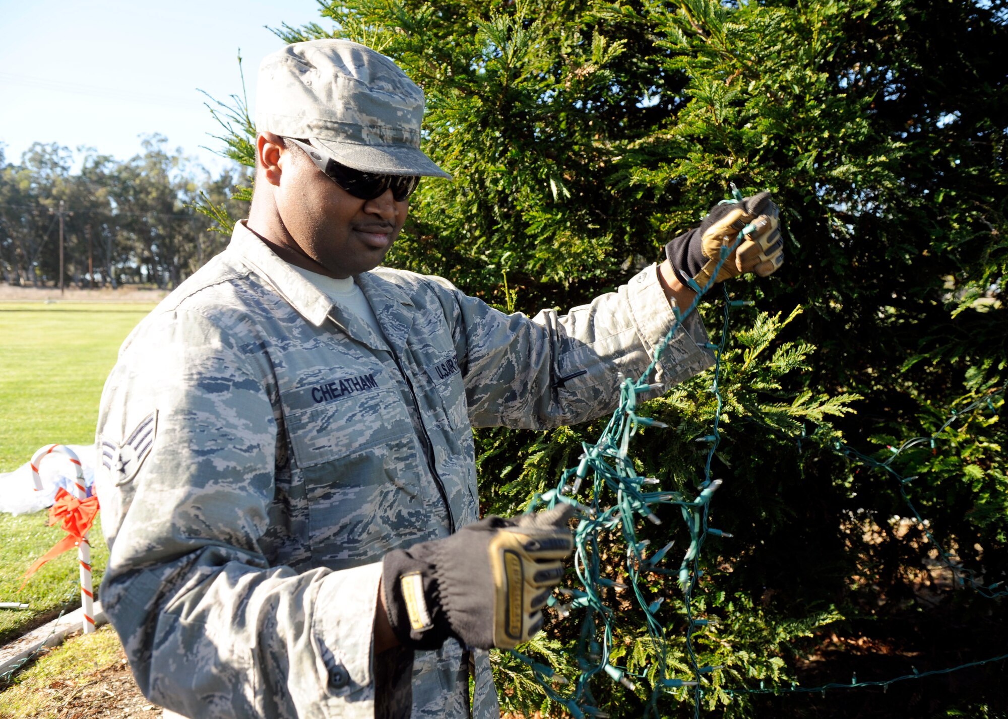 VANDENBERG AIR FORCE BASE, Calif. -- Senior Airman John Cheatham of the 30th Civil Engineer Squadron untangles holiday lights for the tree in front of building 11777 here Wednesday, Nov. 30, 2011. Team Vandenberg personnel and their families are invited to attend the tree-lighting ceremony Tuesday, Dec. 6, 2011, at 4 p.m. (U.S. Air Force photo/Master Sgt. John Peters)