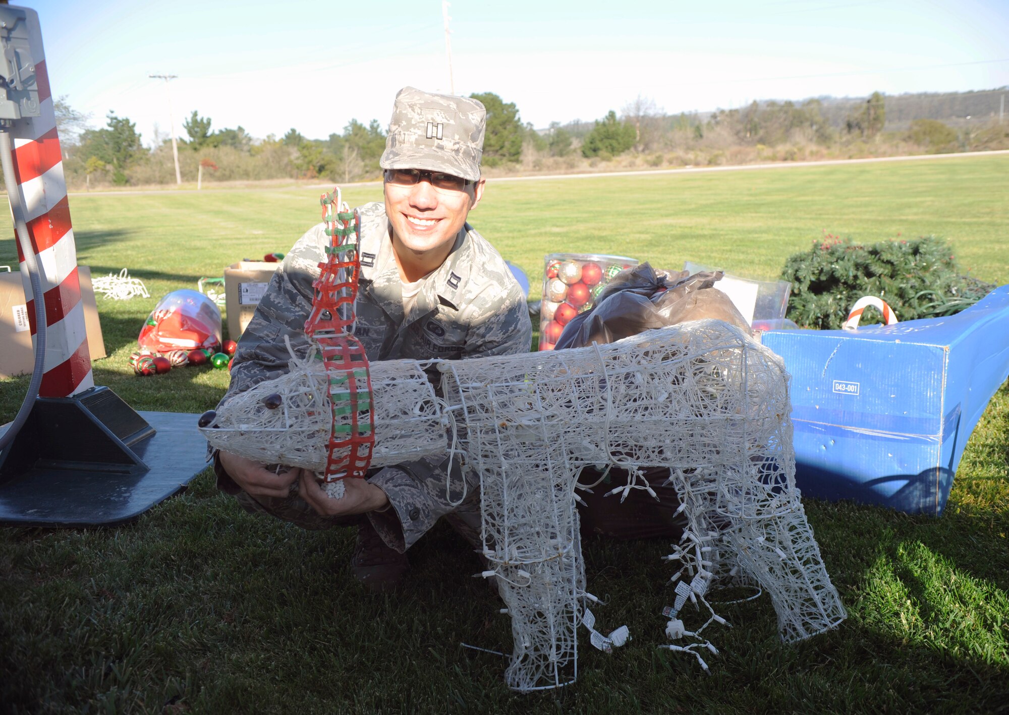 VANDENBERG AIR FORCE BASE, Calif. -- Capt. Charles Skrovan of the 1st Air and Space Test Squadron assembles lighted holiday figurines here Wednesday, Nov. 30, 2011. Team Vandenberg personnel and their families are invited to attend the tree-lighting ceremony in front of building 11777 Tuesday, Dec. 6, 2011, at 4 p.m. (U.S. Air Force photo/Master Sgt. John Peters)