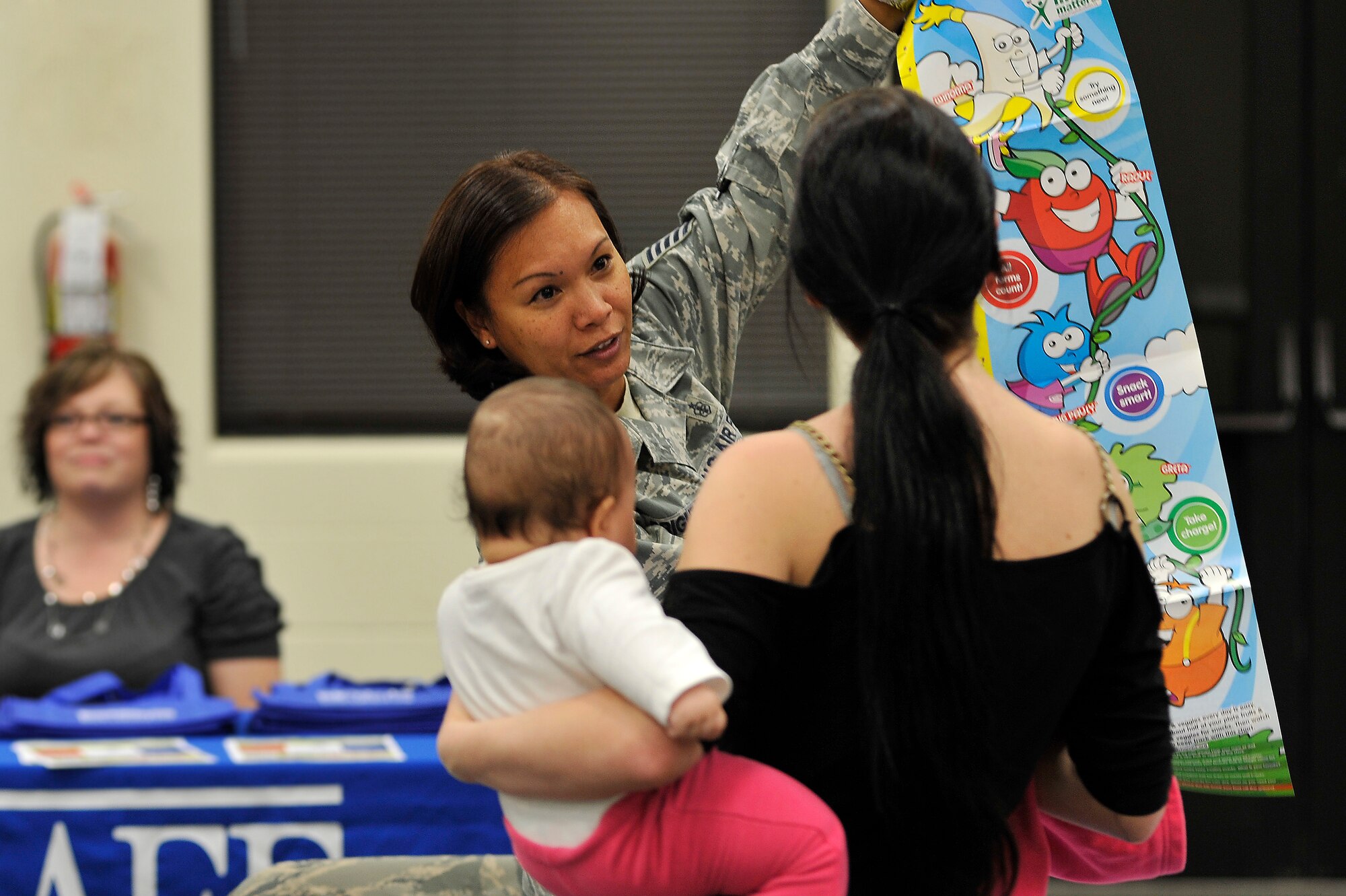 U.S. Air Force Tech Sgt. Suzie Bright, 20th Aerospace Medical Squadron diet technician, displays and explains a children?s health and wellness chart to Betty Baxton, wife of Senior Airman Lawrence Baxton, 609th Air and Space Operations Center Detachment 1, during a military family appreciation event hosted by Shaw?s Airman and Family Readiness Center, Nov. 29, 2011, Shaw Air Force Base, S.C. November marks military family appreciation month and to show their appreciation, the 20th Force Support Squadron Airman and Family Readiness Center organized an event which brought out several local Sumter vendors. There were more than 14 different vendors that provided military members and their families with free information and products. (U.S. Air Force photo by Senior Airman Kenny Holston/Released)


