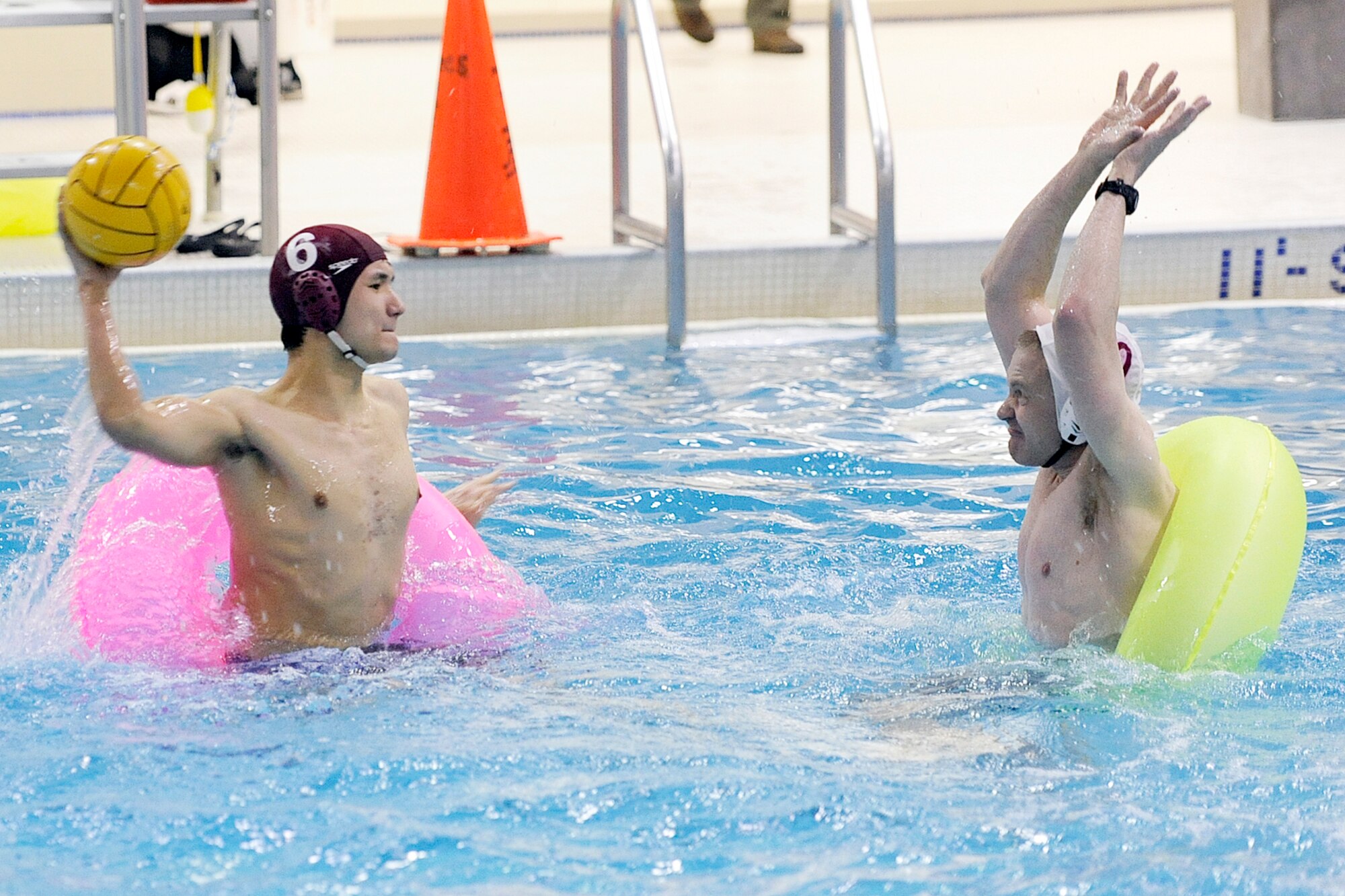 Alan Kempa takes a shot for the 673d Force Support Squadron against the 95th Chemical Company defense in the championship match of the Joint Base Elmendorf-Richardson inner tube water polo tournament Nov. 23 at the Buckner Physical Fitness Center pool. (U.S. Air Force photo/John Pennell)