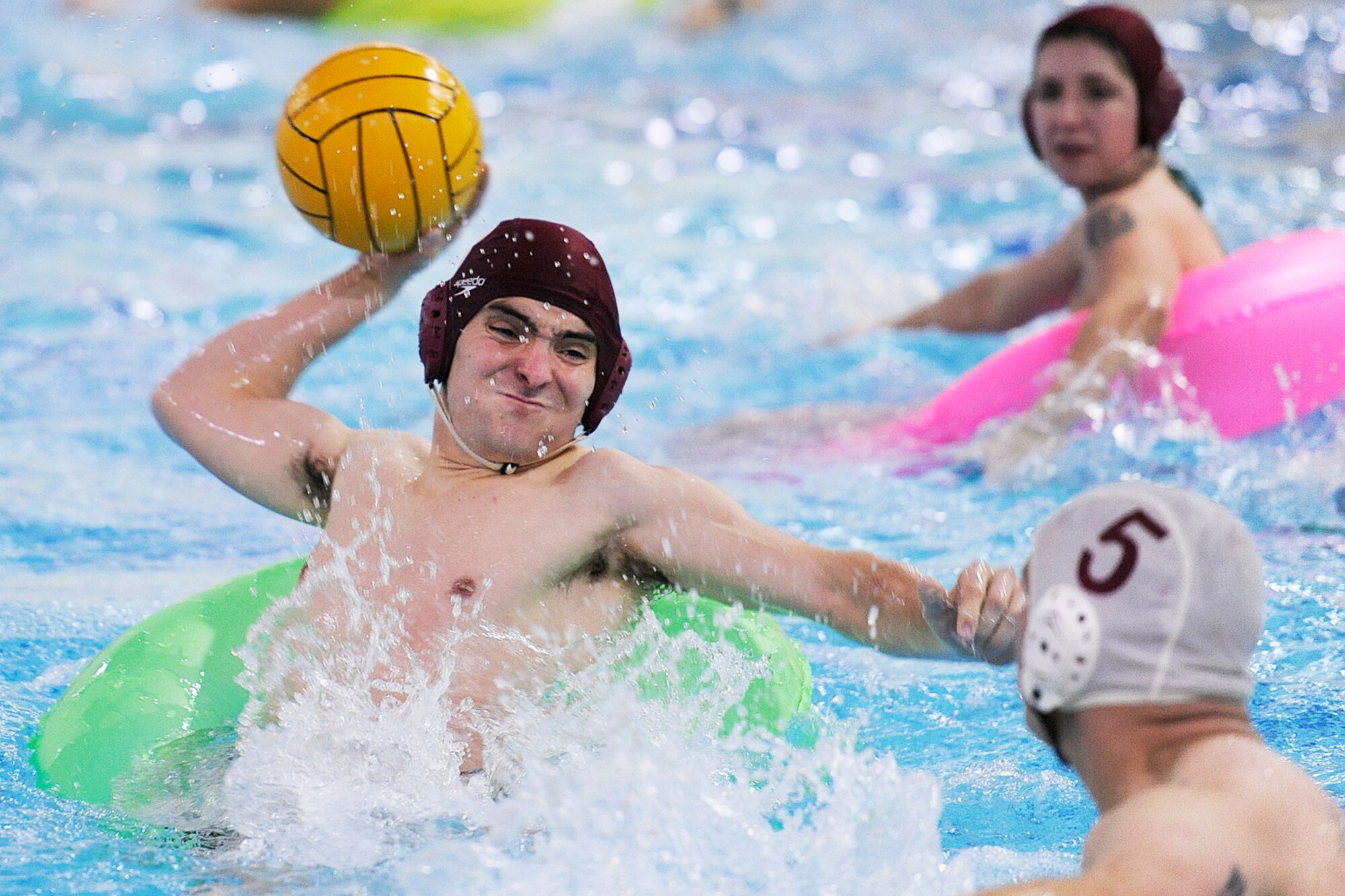Alaska National Guard's Neil Fulsang launches a shot on goal against the C Company, 307th Expeditionary Signal Battalion defense in the third-place game of the Joint Base Elmendorf-Richardson inner tube water polo tournament Nov. 23 in the Buckner Physical Fitness Center pool. (U.S. Air Force photo/John Pennell)
