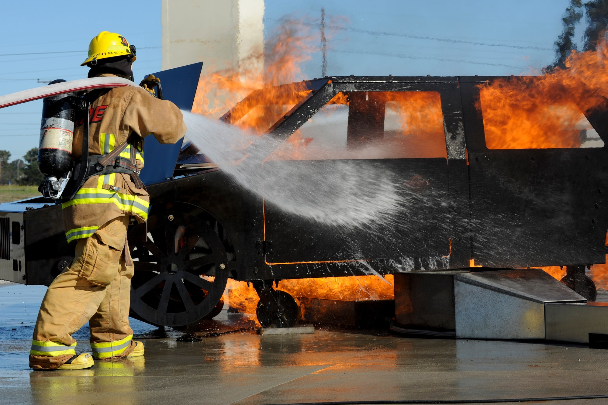 VANDENBERG AIR FORCE BASE, Calif. – A student firefighter from Allen Hancock College Fire Academy puts out a car fire during training at the Turner Bell Fire Training Campus here Wednesday, Nov. 30, 2011. . Allen Hancock College students trained at Vandenberg to help build the required skills while their Public Safety Complex, which will incorporate skill training facilities, is under construction. (U.S. Air Force photo/Staff Sgt. Levi Riendeau)