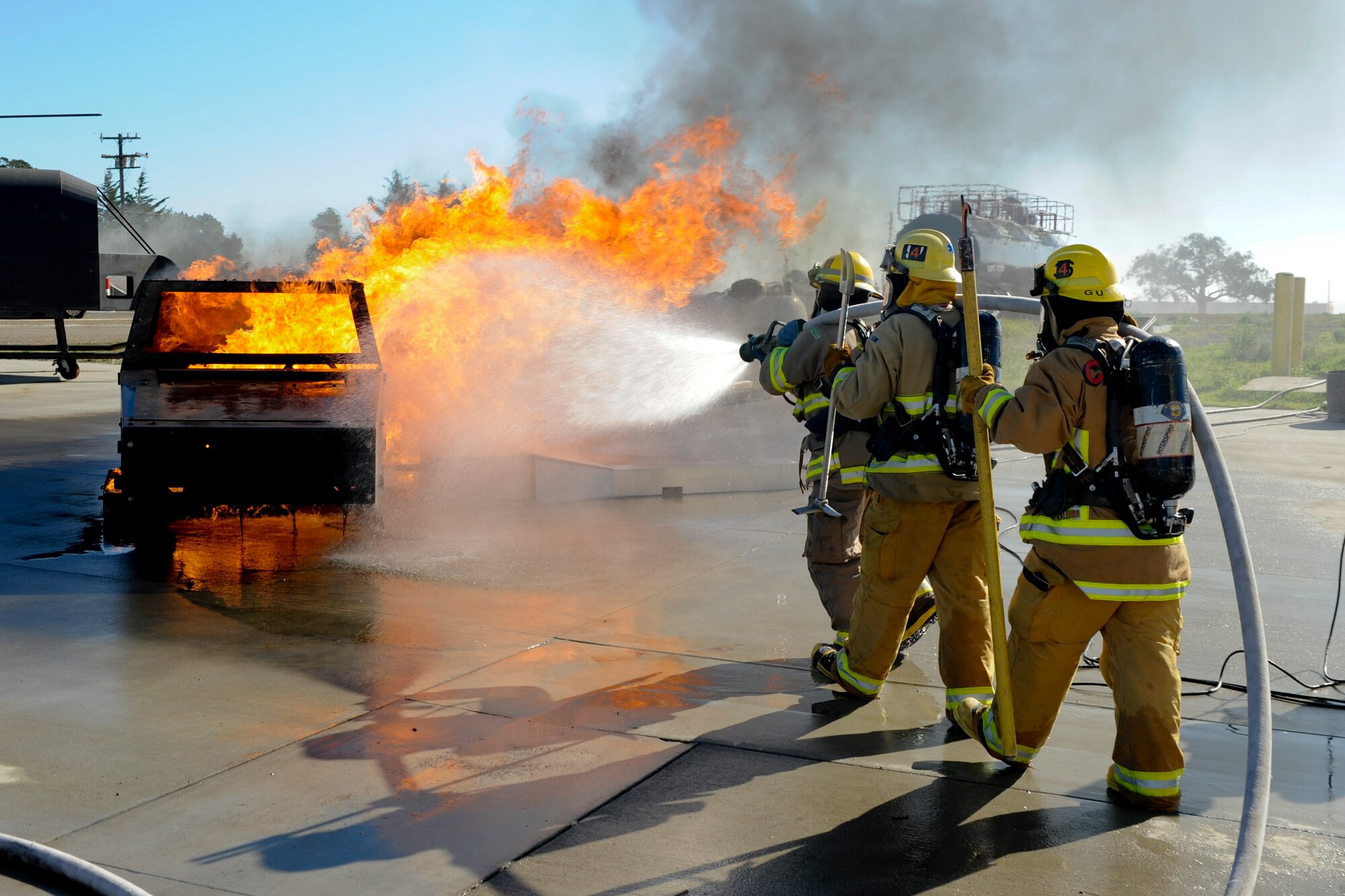 VANDENBERG AIR FORCE BASE, Calif. – A car fire gets extinguished by student firefighters from Allen Hancock College Fire Academy during training at the Turner Bell Fire Training Campus here Wednesday, Nov. 30, 2011. . Allen Hancock College students trained at Vandenberg to help build the required skills while their Public Safety Complex, which will incorporate skill training facilities, is under construction. (U.S. Air Force photo/Staff Sgt. Levi Riendeau)