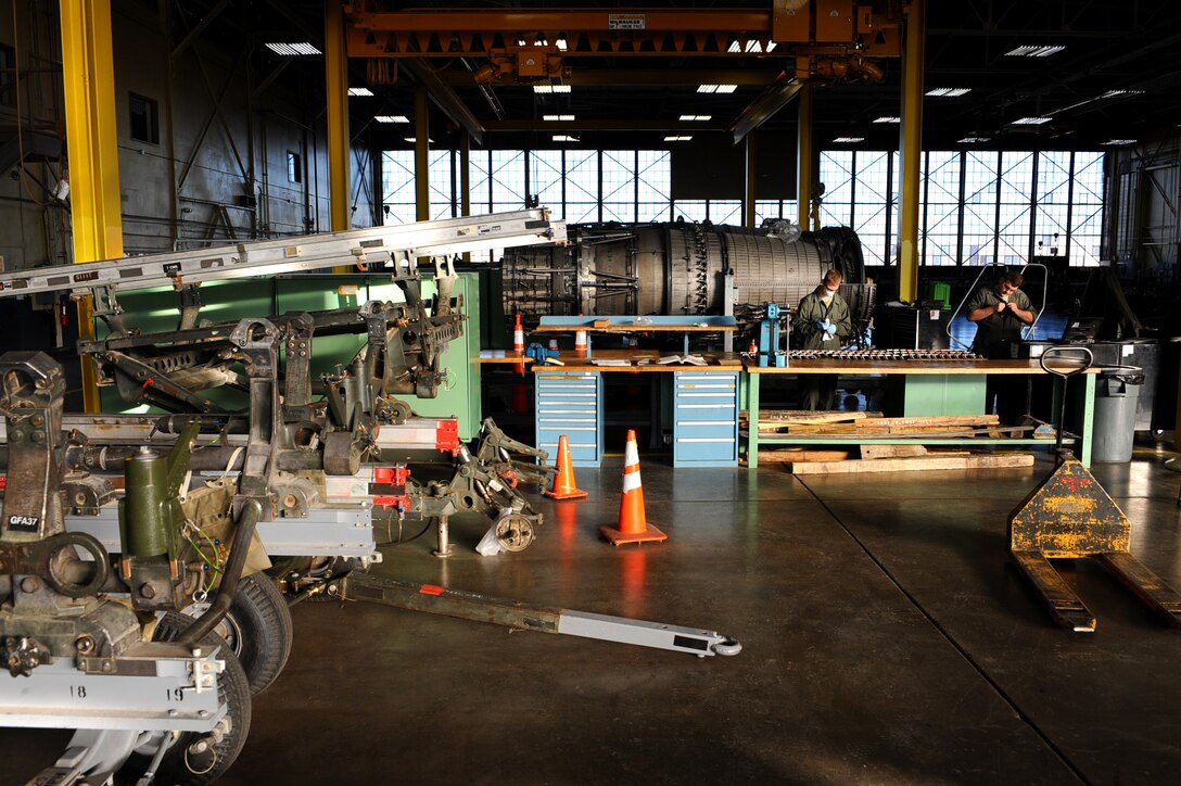 Airman 1st Class Christopher Thomas and Senior Airman Adam Reinert, 28th Maintenance Squadron aerospace propulsion mechanics, clean and inspect second stage engine blades for foreign-object damage at the propulsion flight building on Ellsworth Air Force Base, S.D., Nov. 29, 2011. If blades are dinged, nicked or scratched, the mechanics remove, repair and reinstall them in the engine. (U.S. Air Force photo by Airman 1st Class Zachary Hada/Released)