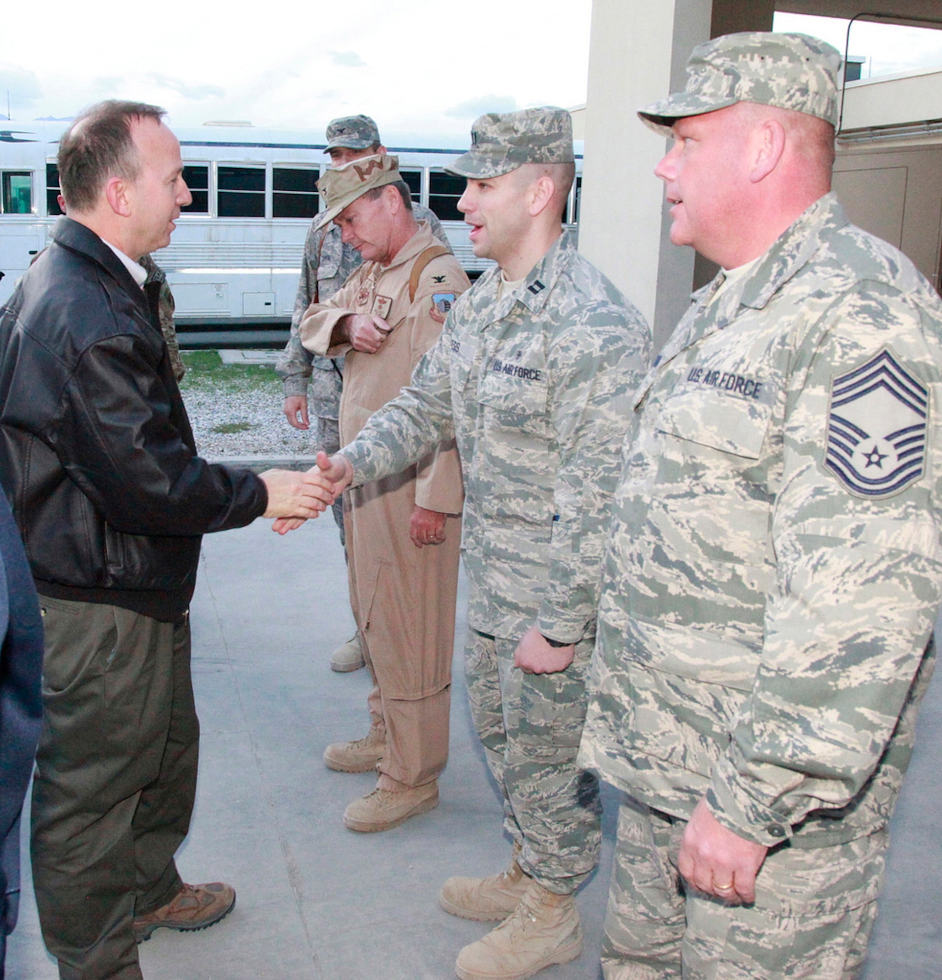 Delaware Governor Jack Markell, left, meets Delaware Airmen at Bagram Air Base, Afghanistan on Nov. 16, 2011. To the left of the governor is Col. Mike Feeley (tan flight suit), deputy operations group commander, 455th Air Expeditionary Wing, Bagram Air Base, Afghanistan, and commander, 166th Operations Group, 166th Airlift Wing, Delaware Air National Guard in New Castle, Delaware. Governor Markell and Connecticut Governor Dannel Malloy spent a day in one nation in Southwest Asia and two days in Afghanistan meeting troops from their respective states. (Courtesy photo/Delaware office of the governor)