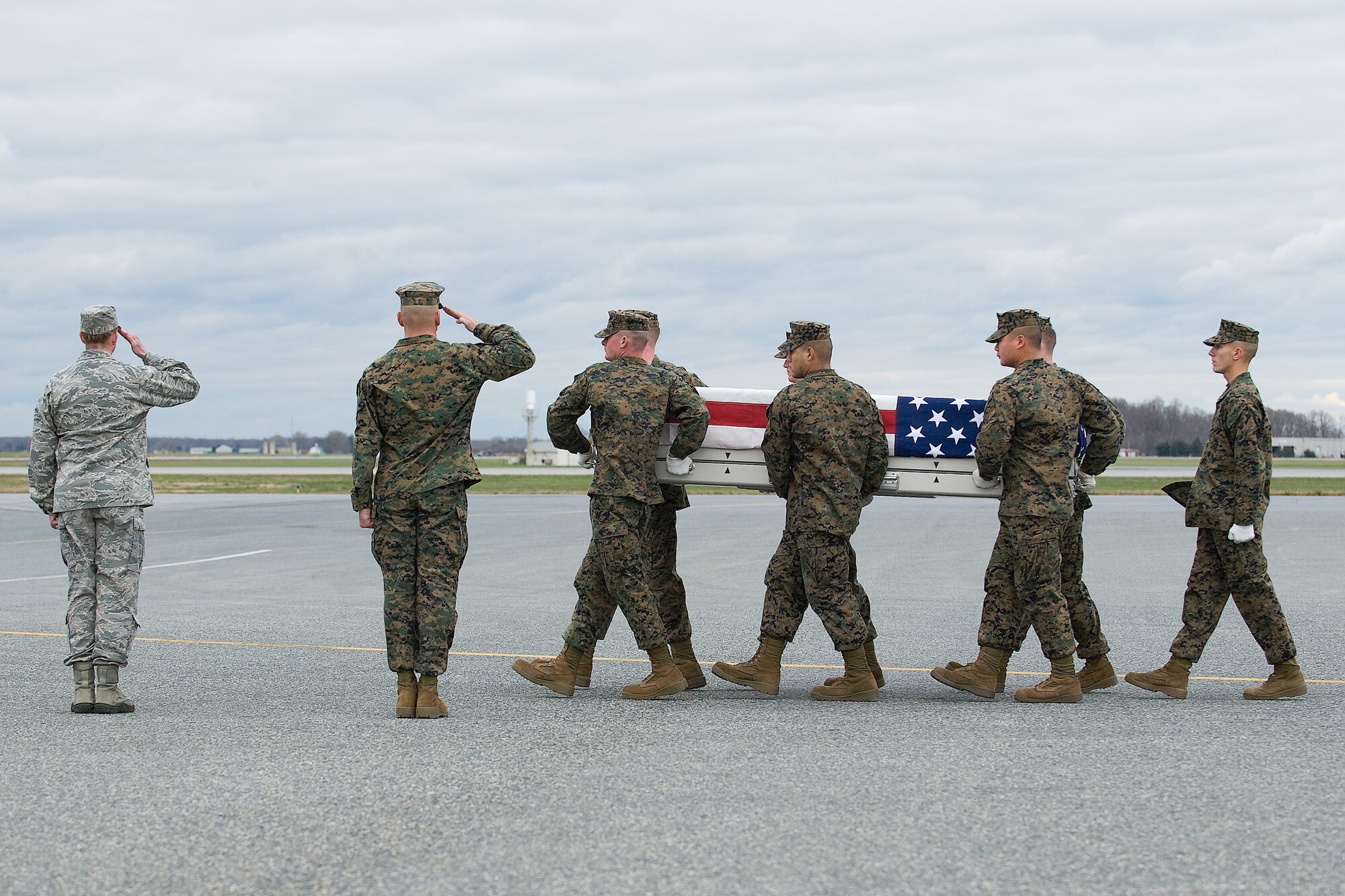A U.S. Marine Corps carry team transfers the remains of Marine Cpl. Adam J. Buyes, of Salem, Ore., at Dover Air Force Base, Del., Nov. 30, 2011. Buyes was assigned to the 3rd Reconnaissance Battalion, 3rd Marine Division, III Marine Expeditionary Force, Okinawa, Japan. (U.S. Air Force photo/Steve Kotecki)