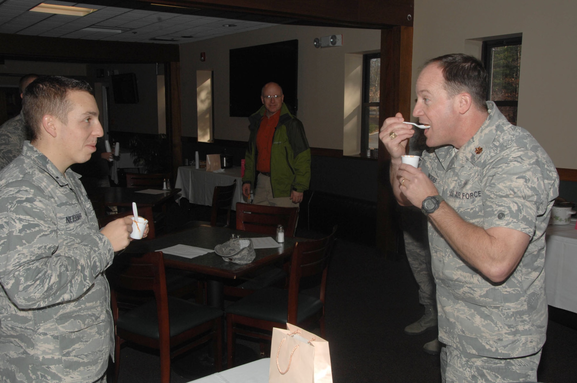 HANSCOM AIR FORCE BASE, Mass. – Chaplain (Maj.) Raymond Moncrief (right) takes a bite of chili as others wait for his reaction during the Combined Federal Campaign chili cook-off at the Minuteman Commons Nov. 22. Attendees could buy tickets and vote on the best traditional, best spicy and best unique batches. Money raised during this event went to a Hanscom charity, Friends of Family Services. (U.S. Air Force photo by Linda LaBonte Britt)