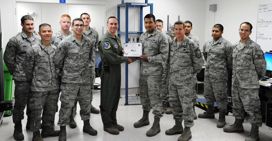 LAUGHLIN AIR FORCE BASE, Texas – Airman 1st Class Kenneth Torres, 47th Flying Training Wing Precision Measurement Equipment Laboratory journeyman, poses with Col. Tom Murphy, 47th FTW commander, after being presented the XLer of the week award here Nov. 16. The XLer is a weekly award chosen by wing leadership and given to those who consistently make outstanding contributions to Laughlin and their unit. (U.S. Air Force photo/Senior Airman Scott Saldukas)
