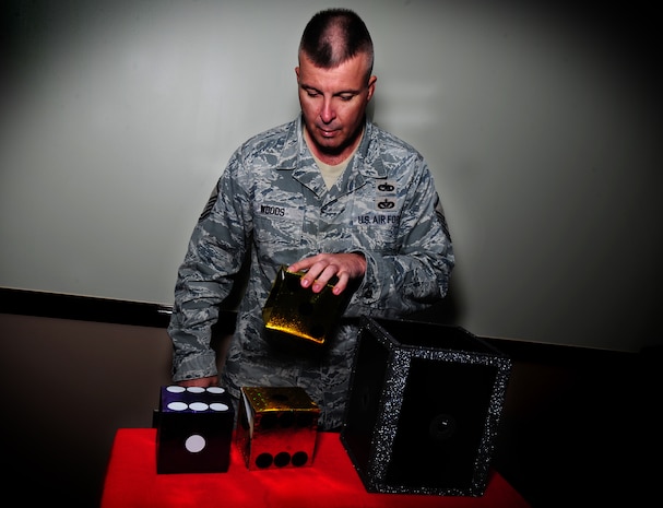 Master Sgt. Perry Woods demonstrates one of his magic tricks at Joint Base Charleston - Air Base Nov. 30. Woods has been in the Air Force for 22-years and has been performing magic since he was nine-years old. He has volunteered to perform his magic shows for local organizations and charities for the past three years. Woods is a program manager with the 437th Maintenance Squadron.  (U.S. Air Force photo/ Staff Sgt. Nicole Mickle)  