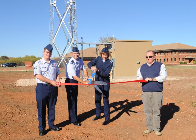 (From left to right) Staff Sgt. Clinton Rowland, 7th Communication Squadron, Maj. Robert Mammenga, 7 CS commander, Col. Kristina O’Brien, 7th Mission Support Group commander, and Mr. Joseph Mason, 7 CS, cut a ribbon Nov. 28, 2011, marking the completion of construction of a new land mobile radio trunking system at Dyess Air Force Base, Texas. The system provides a secure medium of communication and offers encryption capabilities with increased coverage. The project began in 2008 and cost $2.4 million. (U.S. Air Force photo by Airman 1st Class Cierra Bullock/Released)
