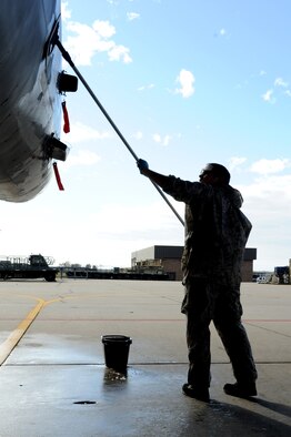 Senior Airman David Nichols uses a scrubber to wash the side of an F-15E Strike Eagle during an aircraft wash on Seymour Johnson Air Force Base, N.C., Nov. 28, 2011. During a jet's washing, Airmen clean the inside of the canopy and the outside of the jet to prevent dirt and corrosion build up. Each jet is washed biannually to aid in the aircraft's longevity. Nichols is a 4th Aircraft Maintenance Squadron crew chief from Hayward, Wis.  (U.S. Air Force photo by Senior Airman Whitney Stanfield)