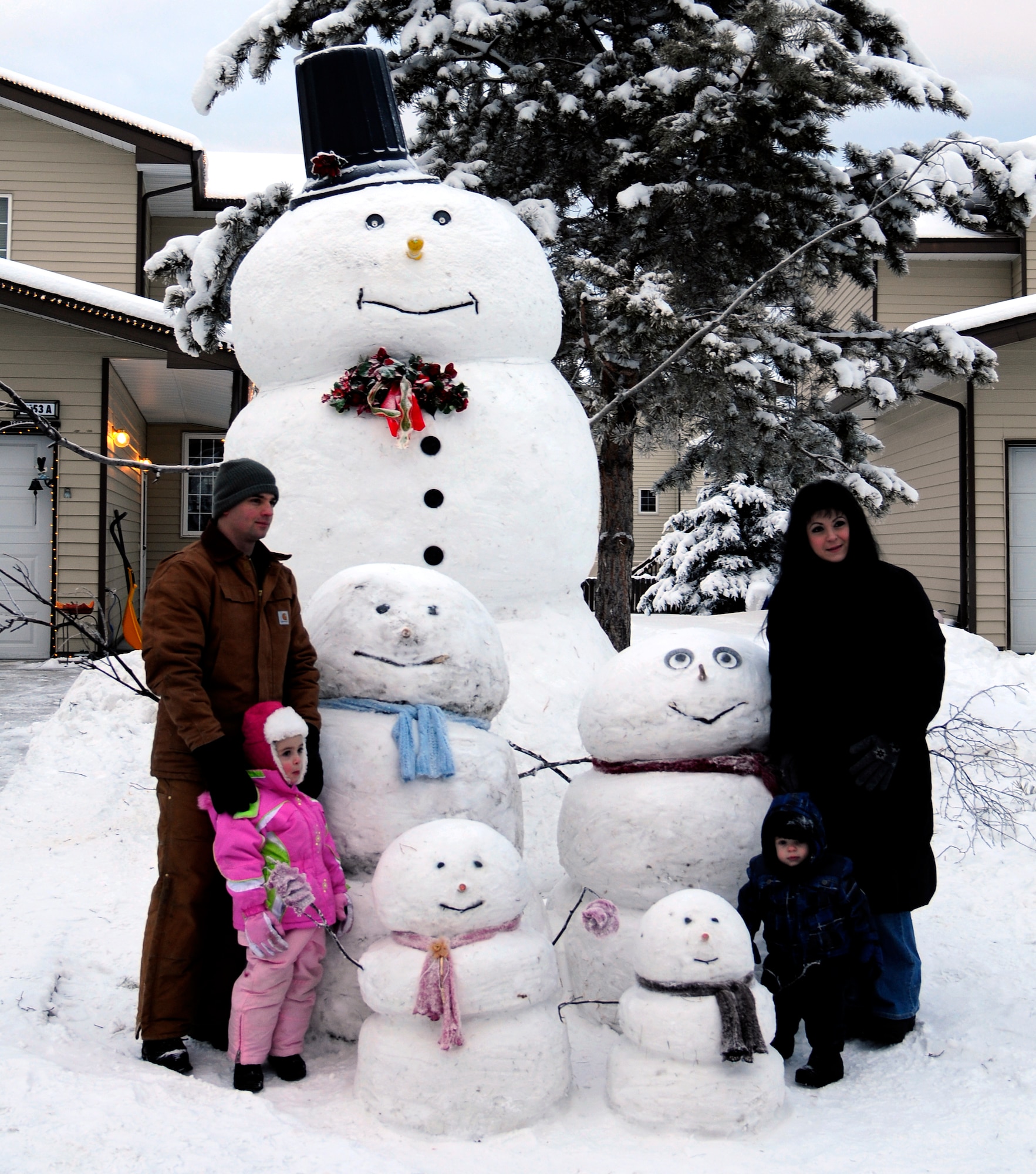 U.S. Air Force Tech. Sgt. Brian Fentress and his family stand alongside their snow clones Nov. 22, 2011, Eielson Air Force Base, Alaska. The family project took Fentress, a 354th Maintenance Group senior maintenance operations center controller, between 50 and 60 hours to complete.  (U.S. Air Force photo/Airman 1st Class Yash Rojas)