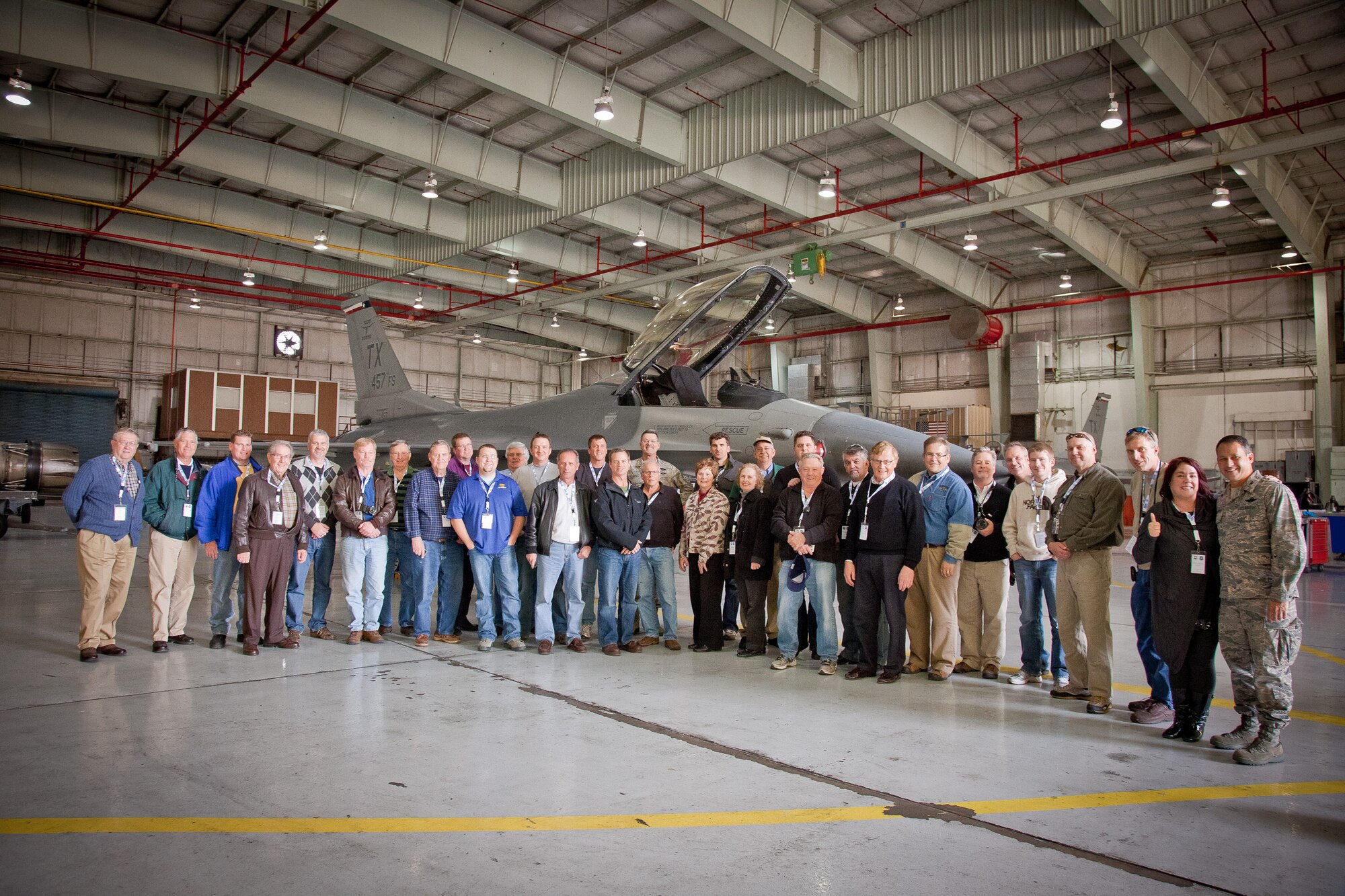 The 934th Airlift Wing Civic Leader Tour 2011 group poses in front of the F-16 Fighting Falcon while touring the hangar at the 301st Fighter Wing in Ft. Worth, Texas.  (Air Force Photo/Shannon McKay)