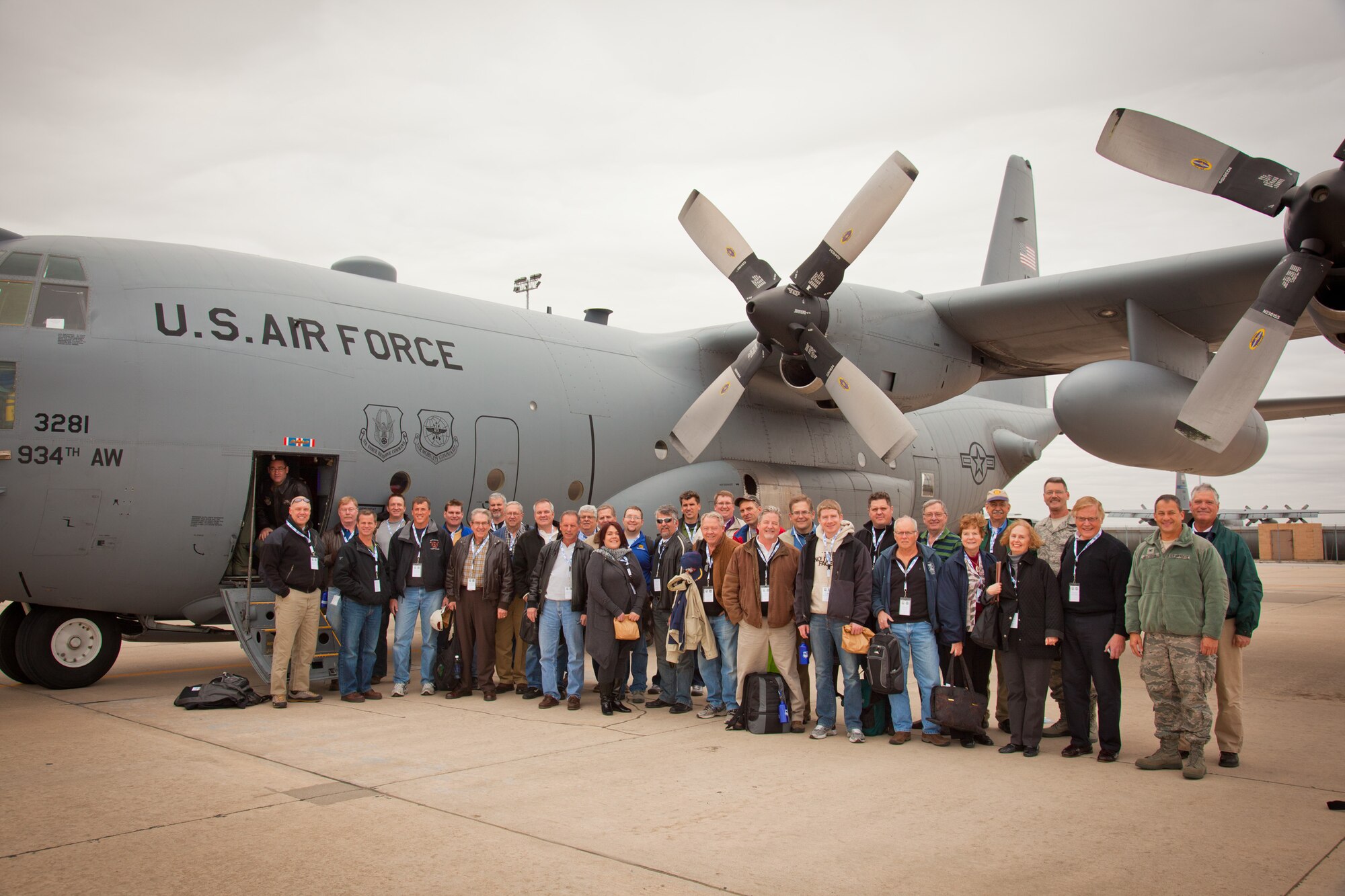 The 2011934th Airlift Wing Civic Leader Tour group poses in front of their transportation, the C-130 Hercules.  The tour promotes community ties and a better understanding of what the Air Force Reserves' mission is and imapct to the local community.  (Air Force Photo/Shannon McKay)