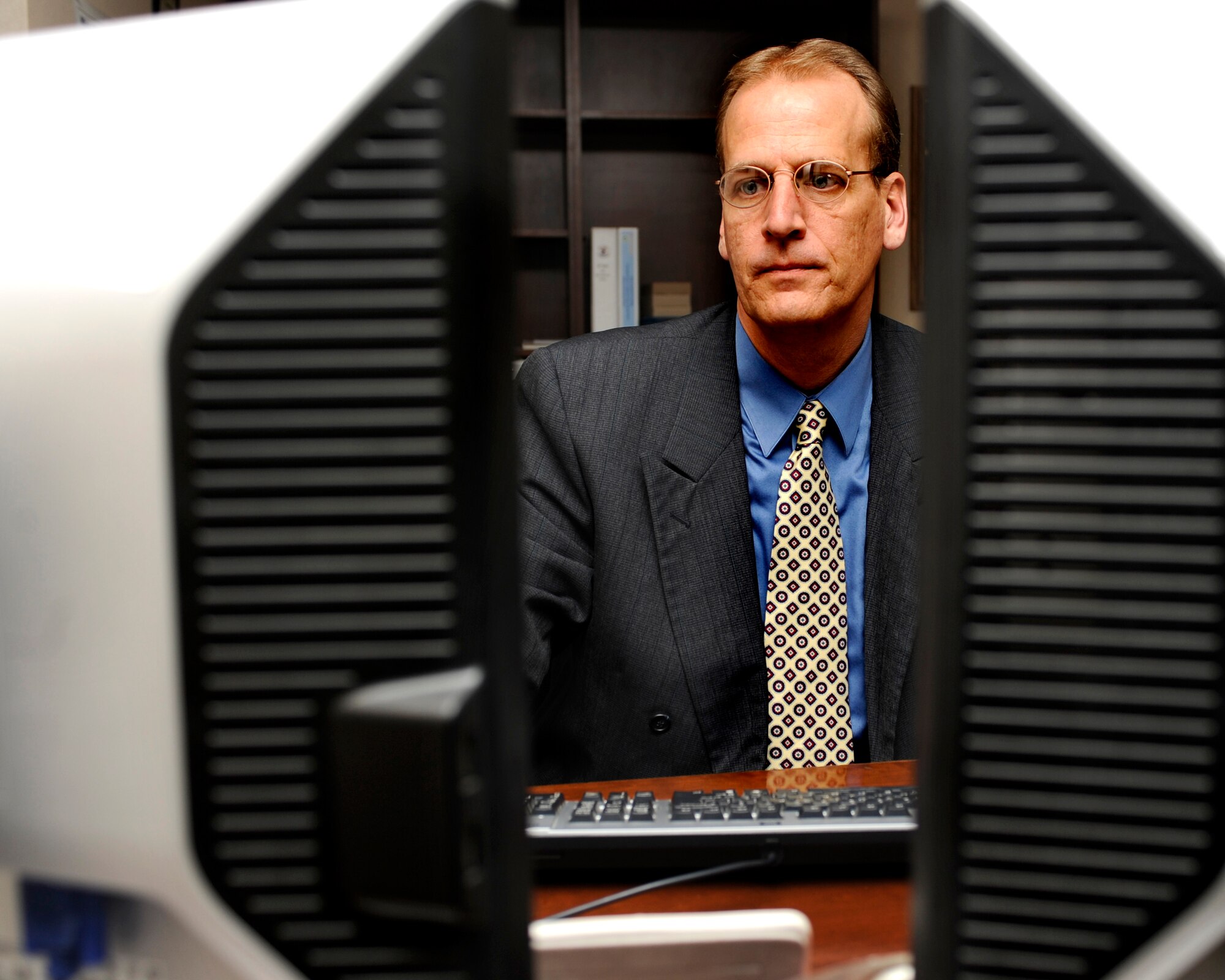 MINOT AIR FORCE BASE, N.D. -- Paul Sullivan, chief of 5th Security Forces Squadron Plans and Programs, works diligently on an award package for an Airman here, Nov. 30. Sullivan received the Air Force Global Strike Command award for Outstanding Security Forces Civilian Employee for the Jan. 1 to Sept. 30, 2011 award period. (U.S. Air Force photo/Airman 1st Class Stephanie Ashley)