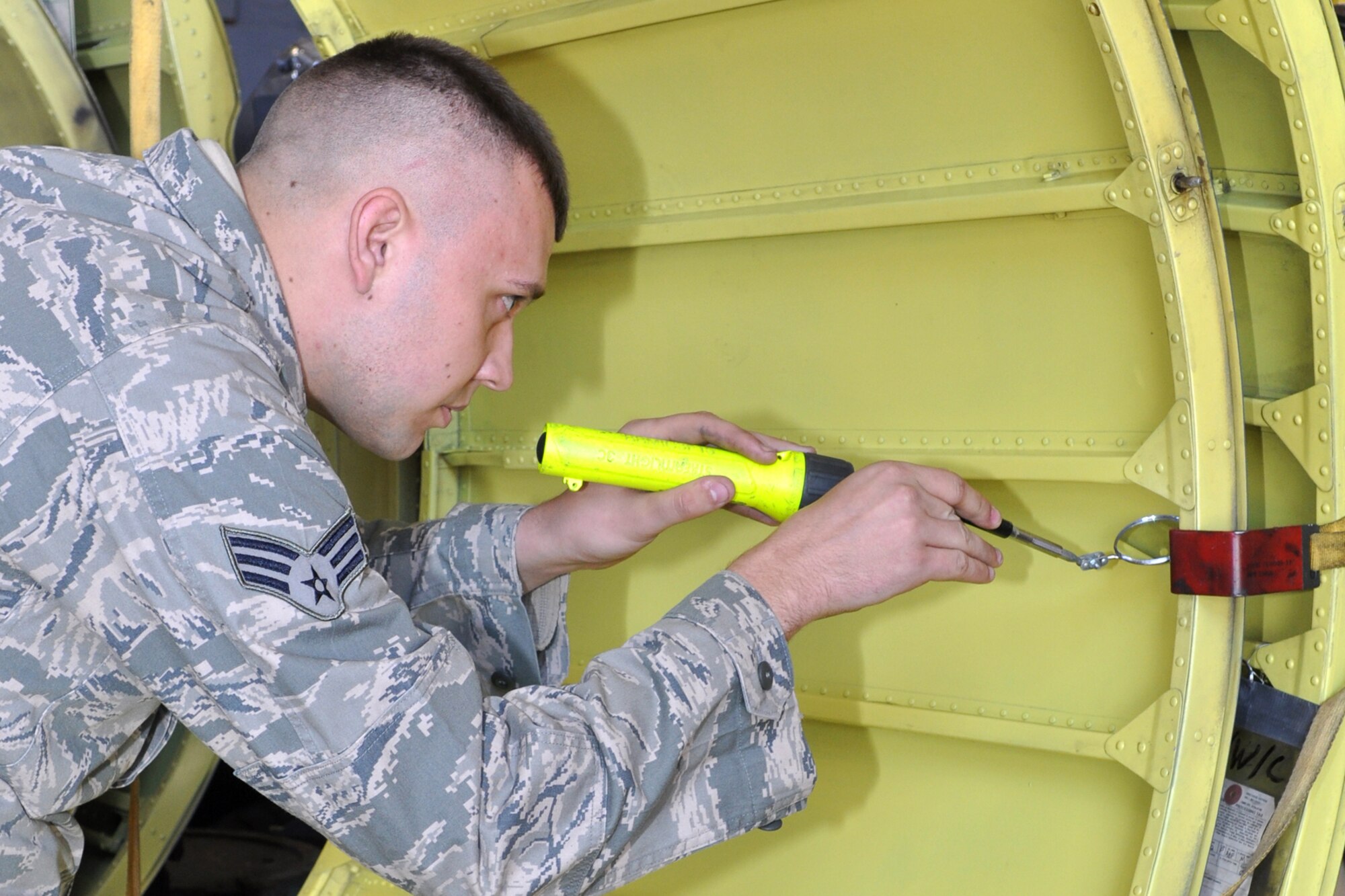 Senior Airman Kyle Johnston, who is a structural repair technician assigned to the 707th Maintenance Squadron does a corrosion inspection on an engine cowl at Barksdale Air Force Base, La., Nov. 9, 2011. (U.S. Air Force photo by Master Sgt. Jeff Walston)
