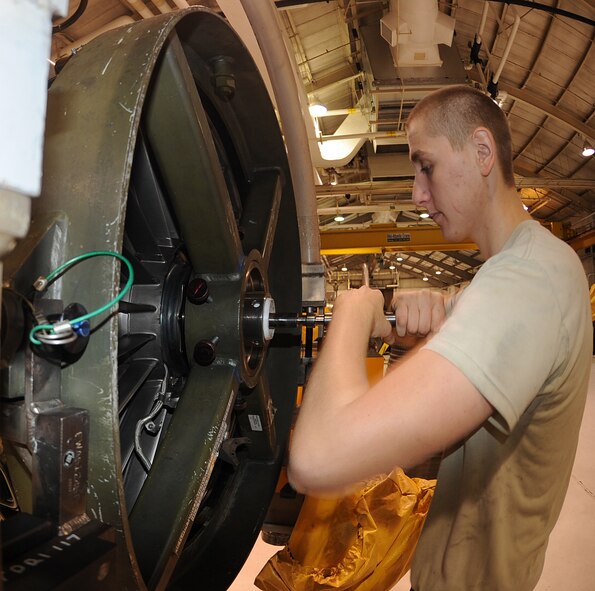 Staff Sgt. Nathan Wietzell, 4th Component Maintenance Squadron jet engine mechanic, loosens the fan drive module on a F-100-220E engine at Seymour Johnson Air Force Base, N.C., Nov. 29, 2011. The fan drive module was determined unserviceable and will be replaced with a new part. The module will cost approximately $300,000 to replace. Wietzell hails from Cresaptown, Md. (U.S. Air Force photo by Senior Airman Gino Reyes)