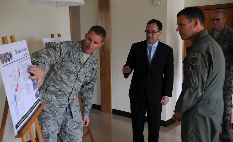 U.S. Air Force Col. Brian Duffy, 18th Civil Engineer Group commander, discusses  family housing statistics with Assistant Secretary of the Air Force (Manpower & Reserve Affairs) Daniel B. Ginsberg and U.S. Air Force Brig. Gen. Matthew Molloy, 18th Wing commander, on Kadena Air Base, Japan, Nov. 30, 2011. Military family housing belonging to Kadena Air Base is comprised of more than 7,000 units - the largest amount of any base in the Air Force. (U.S. Air Force photo by Staff Sgt. Christopher Hummel/Released)