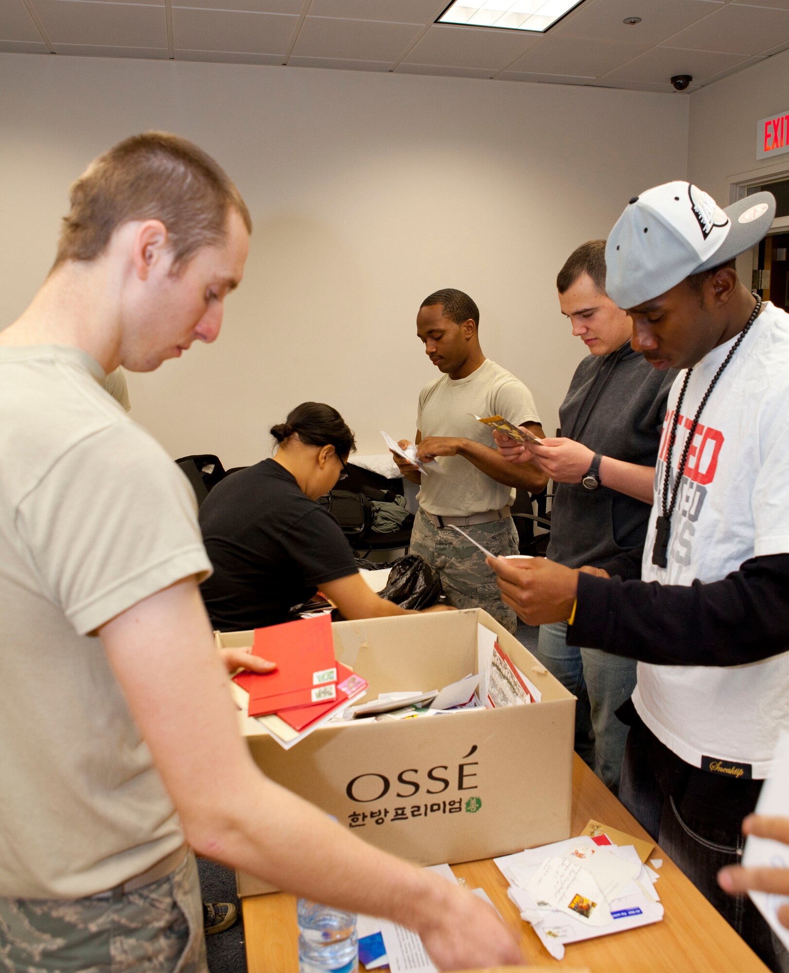 Osan volunteers sort cards Nov. 22 during the 5th annual Holiday Mail for Heroes program. The program, facilitated by the American Red Cross, was developed so military members can receive holiday greetings from back home. (U.S. Air Force photo/Staff Sgt. Rick Maricle)