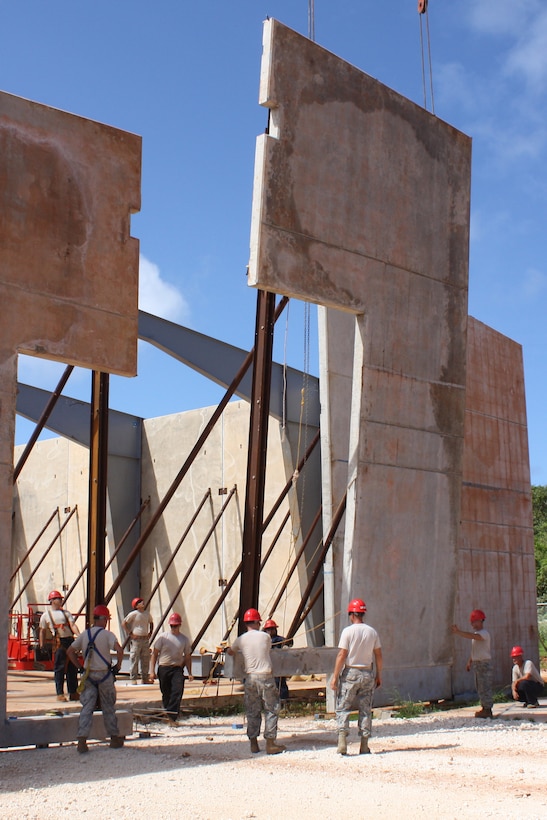 ANDERSEN AIR FORCE BASE, Guam- A pre-cast tilt-up panel is slowly positioned into its place as part of the vertical special capabilities warehouse in North West Field, Nov. 22. The VSC is a one year project being built with pre-cast tilt-up panels, and when complete the building will be a storage for specialized construction equipment. (U.S. Air Force photo courtesy photo)