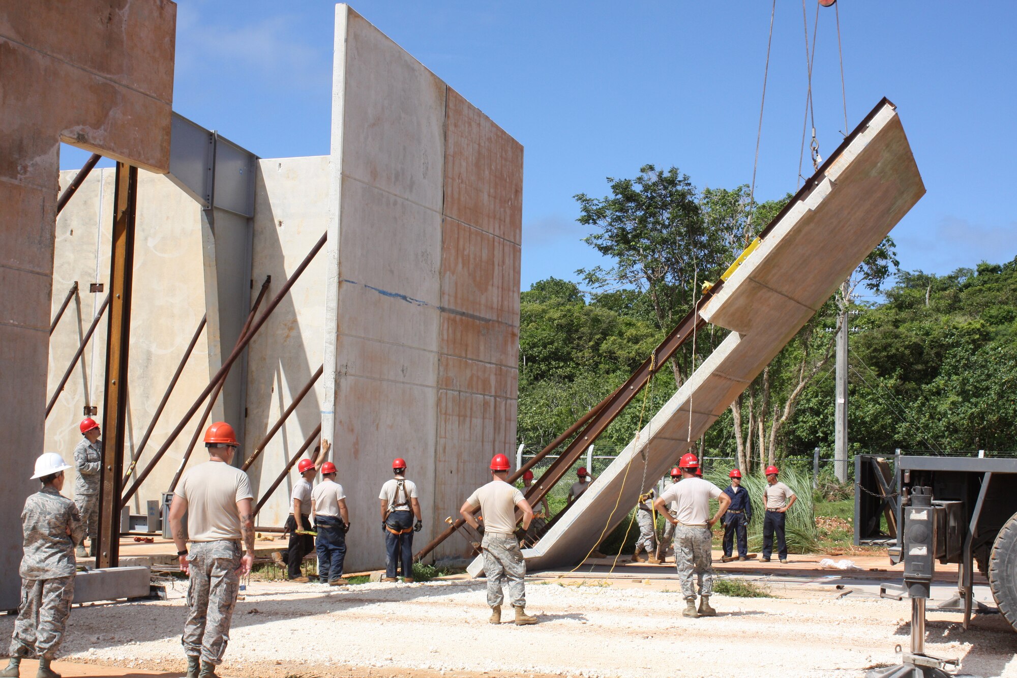 ANDERSEN AIR FORCE BASE, Guam- A pre-cast tilt-up panel is lifted by a crane to be put into place during construction of the vertical special capabilities warehouse, Nov. 22. The VSC is a one year project being built with pre-cast tilt-up panels, and when complete the building will be a storage for specialized construction equipment. (U.S. Air Force photo courtesy photo)