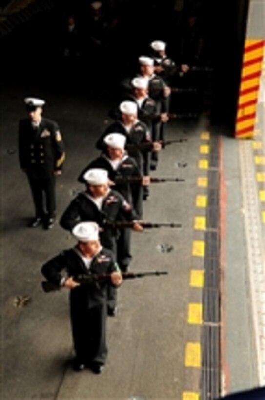 An honor detail conducts a rifle volley during a memorial service aboard the aircraft carrier USS Enterprise (CVN 65) in Norfolk, Va., on Nov. 28, 2011.  The remembrance is part of the ship's 50th birthday celebrations honoring the sacrifice of former Enterprise sailors.  The Enterprise is scheduled to deploy for the last time this spring.  