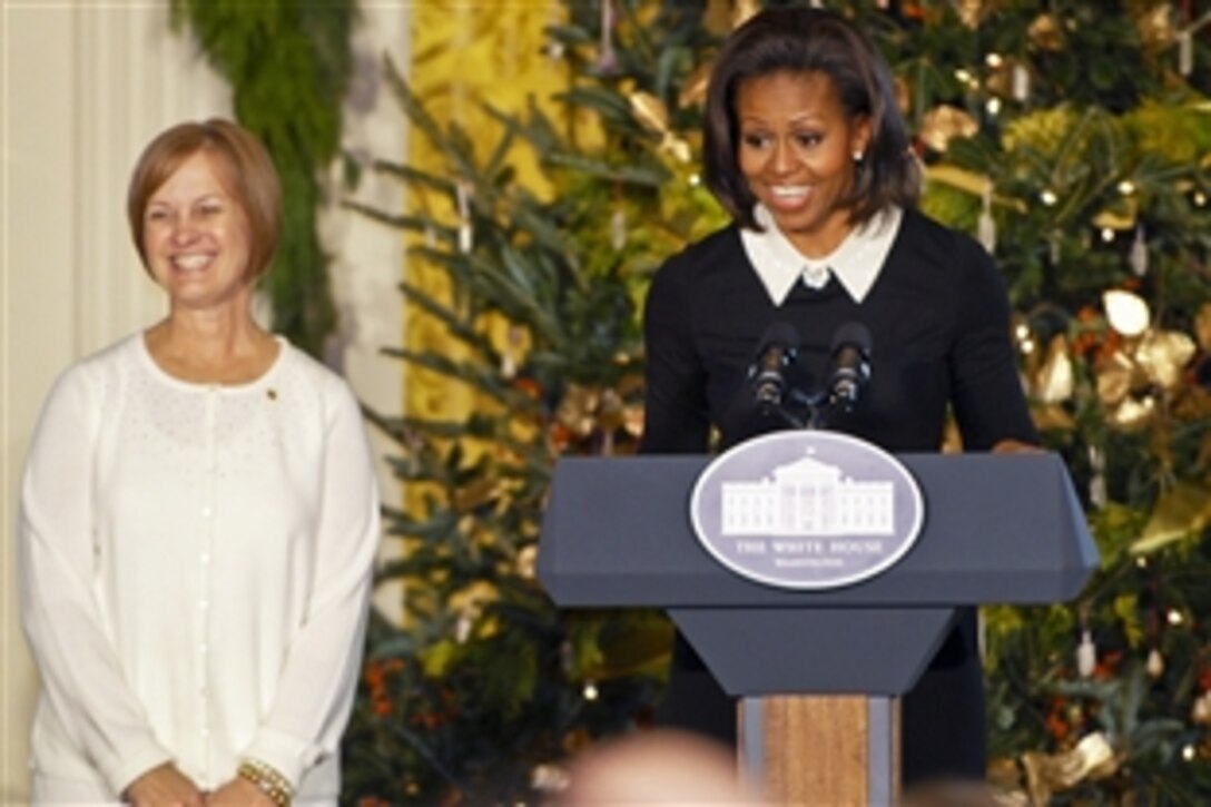 First Lady Michelle Obama launches a holiday event for military families as Jennifer Jackman of American Gold Star Mothers stands by her side at the White House in Washington, D.C., Nov. 30, 2011. The first lady invited military families, including families of the fallen, to be among the first to view the White House's holiday decorations. During the event, military children decorated cookies and created ornaments.
