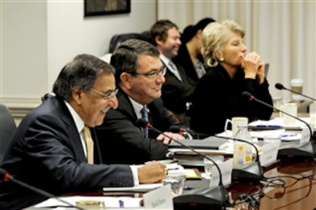 Defense Secretary Leon E. Panetta, left, and Deputy Defense Secretary Ashton B. Carter listen to a briefing by John Hamre, Defense Policy Board chairman, at the Pentagon, Nov. 30, 2011.  Board members concluded two days of meetings by offering recommendations on a variety of international security issues. The board, which includes internationally recognized security policy experts, was established to provide independent analysis, recommendations and opinions on defense issues.