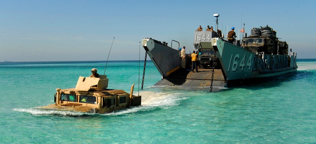 A Humvee launches from a landing craft utility assigned to amphibious dock landing ship USS Whidbey Island (LSD 41). Whidbey Island is deployed as part of the Bataan Amphibious Ready Group, supporting maritime security operations and theater security cooperation efforts in the U.S. 5th Fleet area of responsibility. (Photo by: Mass Communication Specialist 3rd Class James Turner)