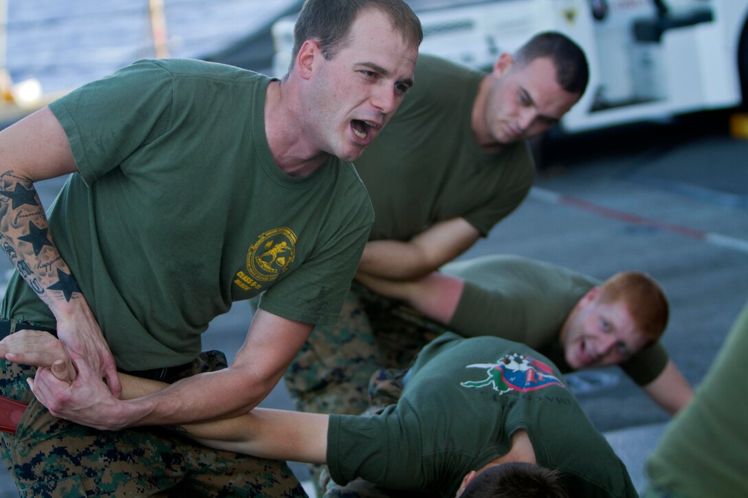 Cpl. Timothy A. Ainsworth demonstrates a wrist-lock technique aboard the amphibious transport dock New Orleans for exercise here Nov. 30. Ainsworth is a 27-year-old Lufkin, Texas, native and a team leader with Company L. The Pendleton-based company is one of three rifle companies with Battalion Landing Team 3/1, the ground combat element for the 11th Marine Expeditionary Unit, which embarked USS Makin Island, USS New Orleans and USS Pearl Harbor in San Diego Nov. 14, beginning a seven-month deployment to the Western Pacific and Middle East regions.
