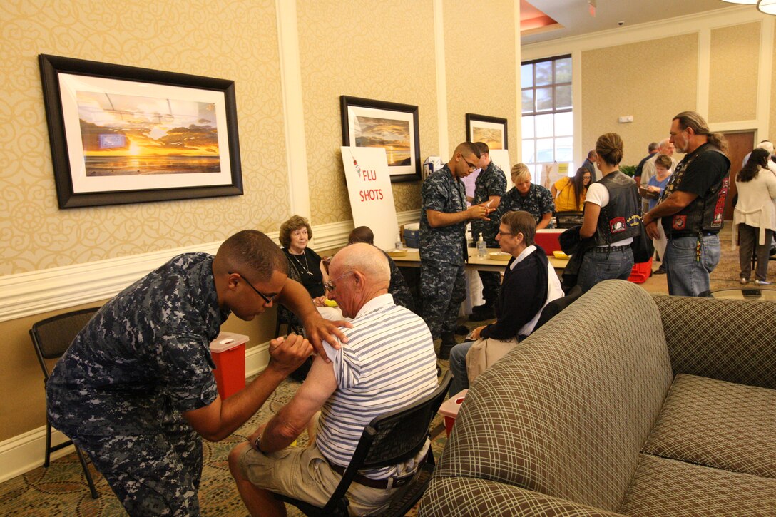 Retired service members and families line-up to receive influenza shots during the annual Retiree Appreciation Day event at Marston Pavilion aboard Marine Corps Base Camp Lejeune, Saturday. Retirees were informed about projects and programs aboard the base, and provided a health fair for attendees.