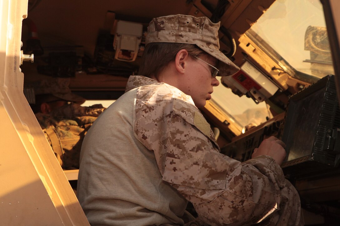 Cpl. Kylie Weaver, a Marine Wing Support 371 field radio operator, and native of Malabar, Fla., readies one of the squadron’s vehicles for a mission at Camp Leatherneck, Afghanistan, Oct. 1. Weaver, who deployed to Afghanistan with Marine Wing Support Squadron 372 in 2010, said she’s surprised by how much Camp Leatherneck  has developed over the past year. “I thought I was going to recognize a lot more,” she said. “Leatherneck has expanded quite a bit.”