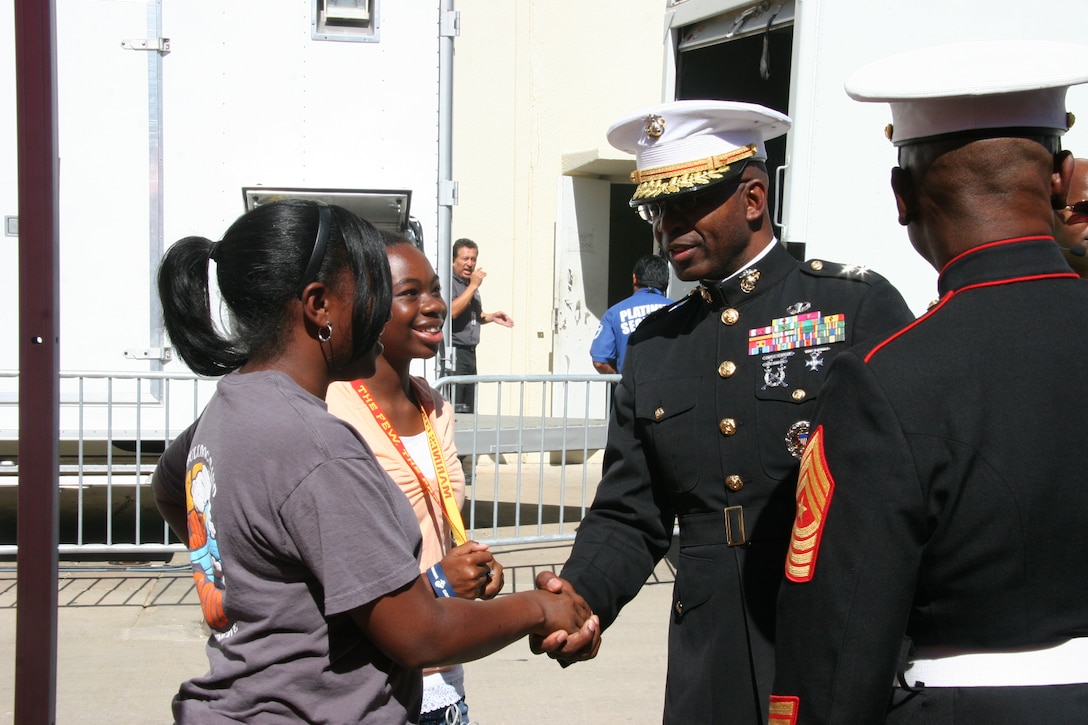 Maj. Gen. Ronald L. Bailey, commanding general of the 1st Marine Division, shakes hands with college students at the Texas State Fair Classic in early October, in Dallas.  Bailey and several other Marines attended the game to provide African-American students with more information on a viable career path in the Corps, during the matchup between two historically black colleges, Prairie View A&M University and Grambling State University.