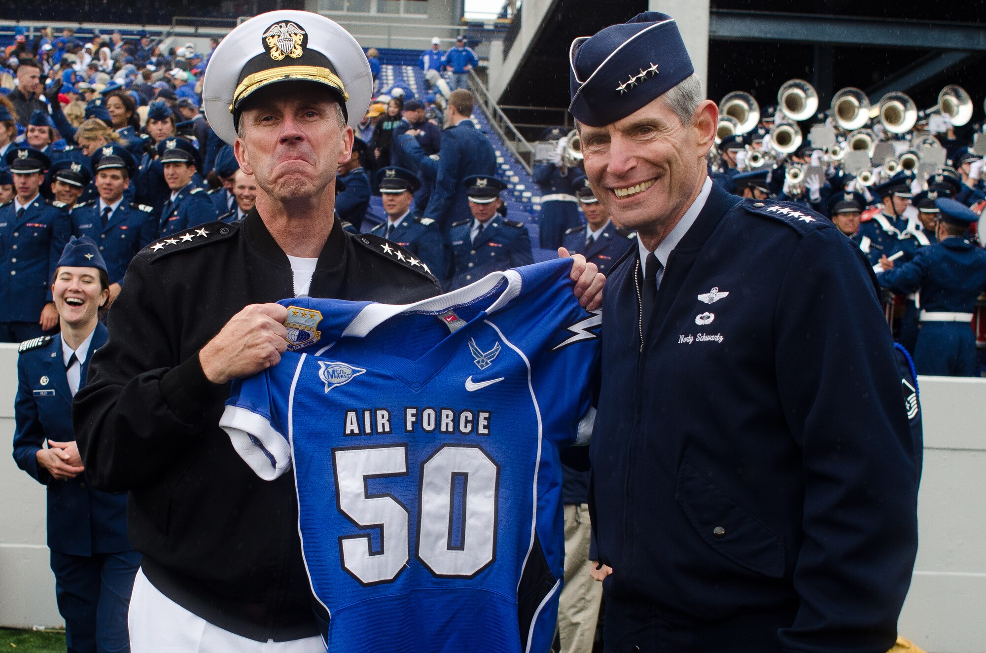Air Force Chief of Staff Gen. Norton Schwartz has the Chief of Naval Operations Adm. Jonathan Greenert pose with a Falcons jersey to after the Falcons beat the Midshipmen of Navy Saturday, Oct. 1, 2011 at the Naval Academy's Jack Stephens Field. The Falcons dominated the first half, but almost let go of the game in the second after the Mids outscored them 25-7. The Falcons won 35-34 in overtime after Falcon linebacker Alex Means' block of Mids kicker Jon Teague point-after attempt. (U.S. Air Force photo/Russ Scalf)