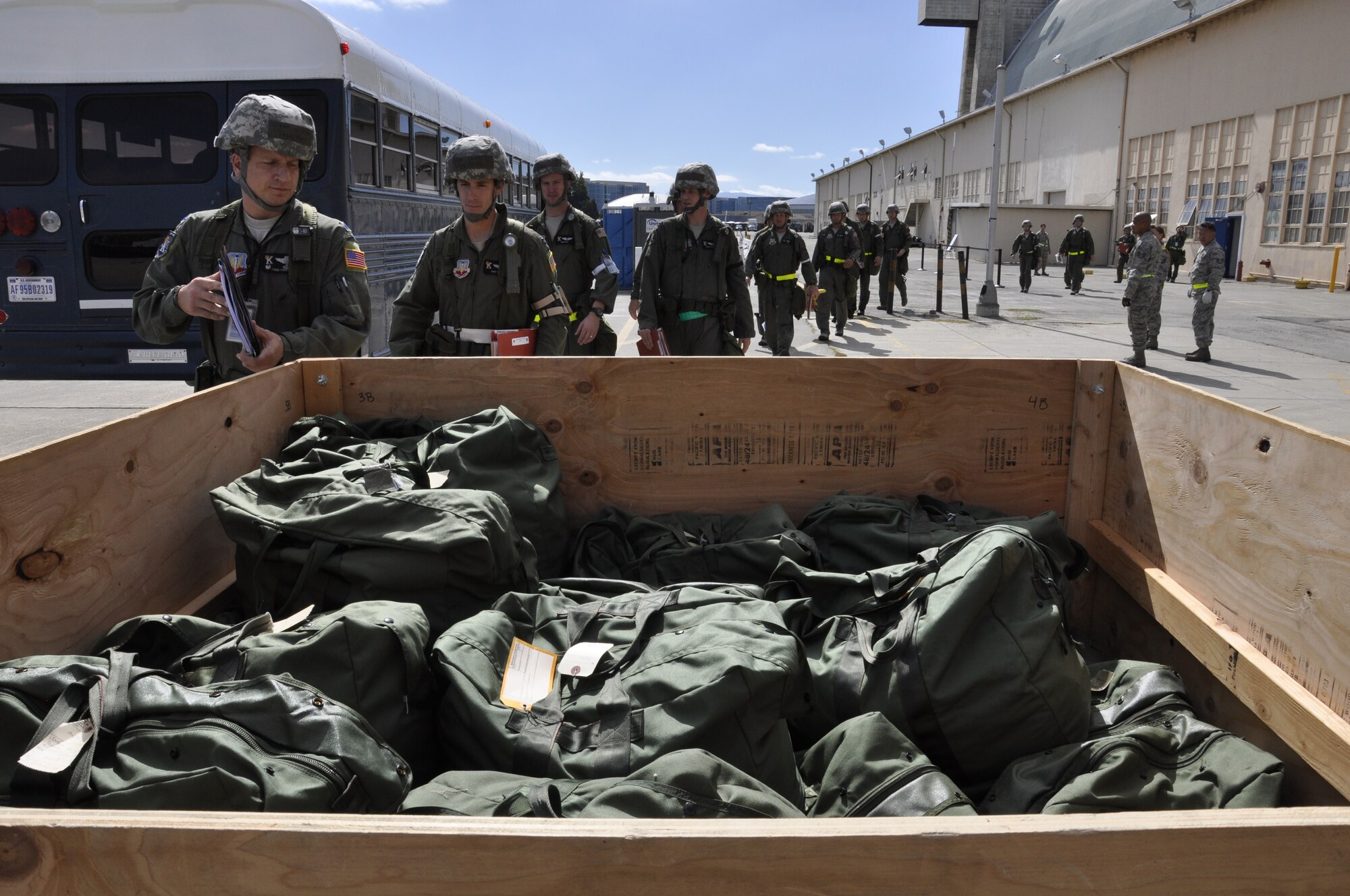 California Air National Guardsmen with the 130th Rescue Squadron grab deployment bags while participating in a Phase 1 Operational Readiness Exercise at Moffett Federal Airfield, Calif., Oct. 1, 2011.  (Air National Guard photo by Airman 1st Class John Pharr)