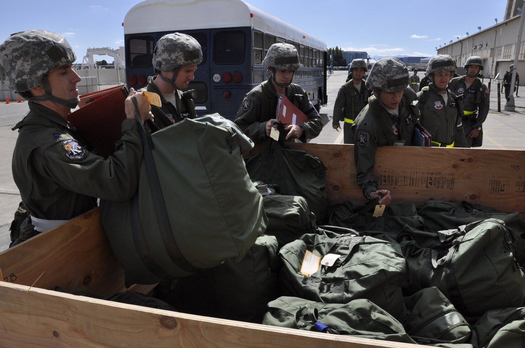 California Air National Guardsmen with the 130th Rescue Squadron grab deployment bags while participating in a Phase 1 Operational Readiness Exercise at Moffett Federal Airfield, Calif., Oct. 1, 2011.  (Air National Guard photo by Airman 1st Class John Pharr)
